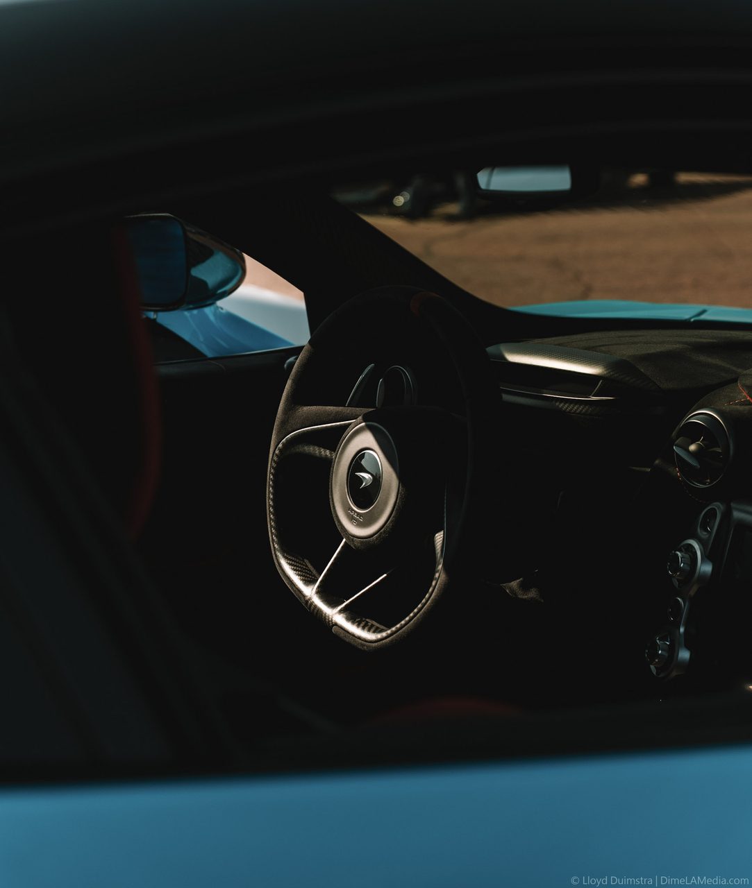 Carbon McLaren steering wheel seen through the side window