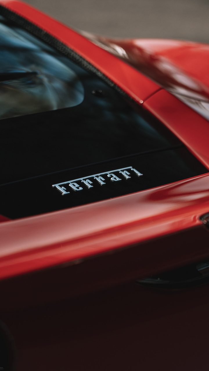 Chrome Ferrari script on the rear glass of a red F8