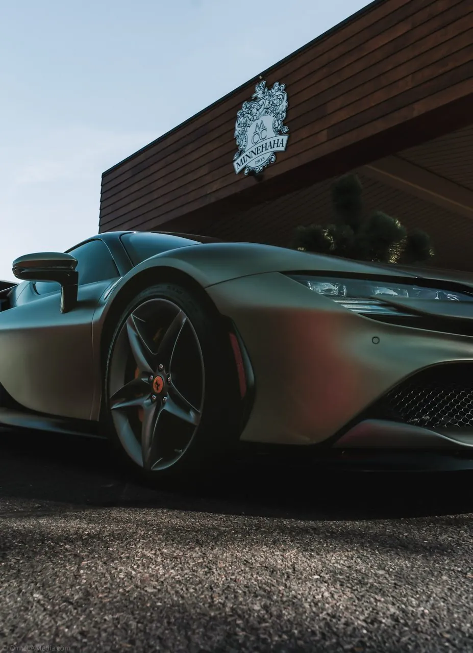 Silver Ferrari wheel with yellow brake caliper on a red F8