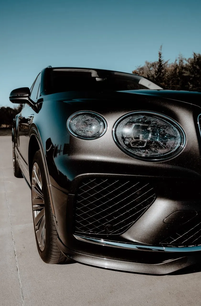 Front detail of a black Bentley Bentayga headlights and grille