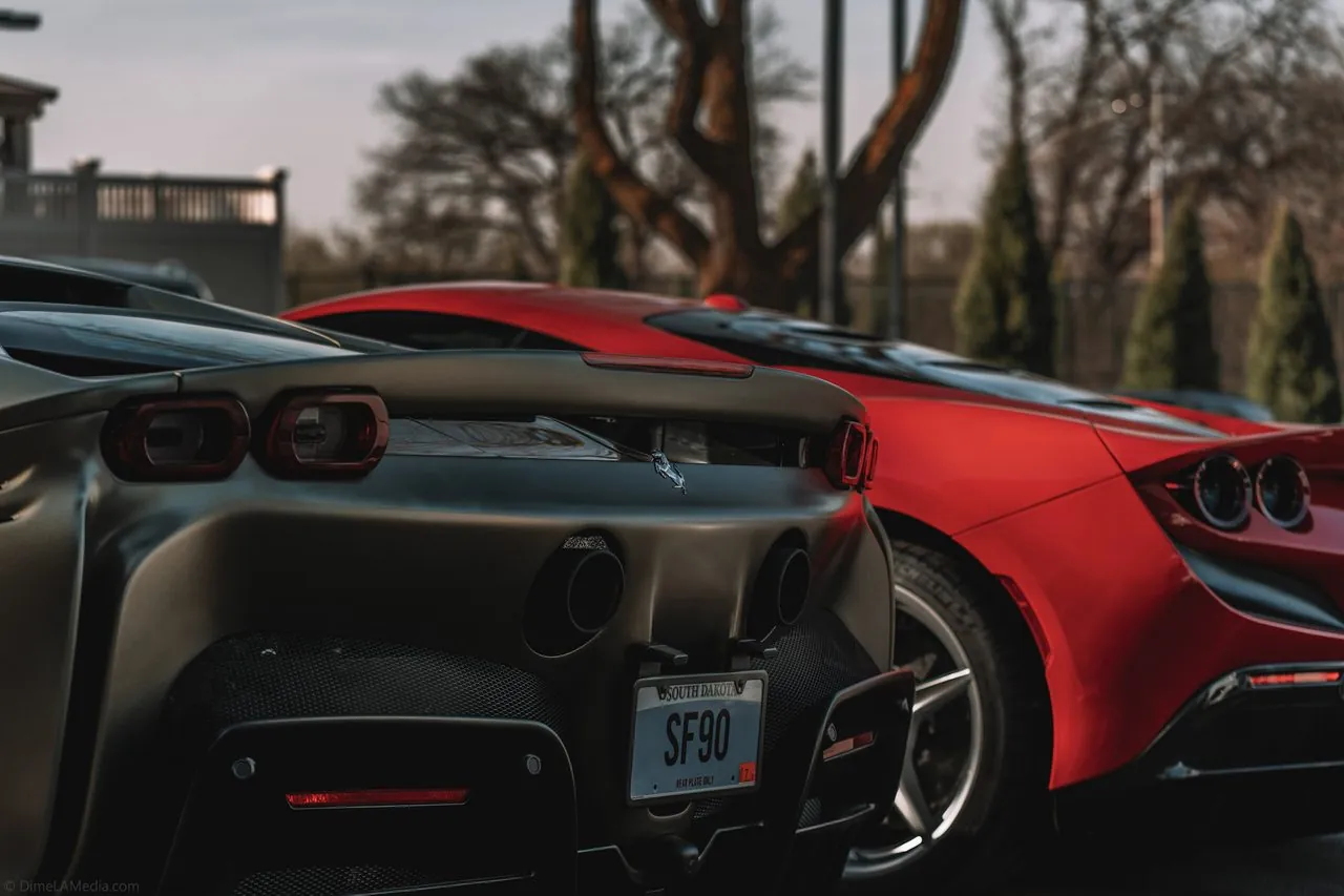Ferrari SF90 and F8 rear ends side by side with an SF90 South Dakota plate