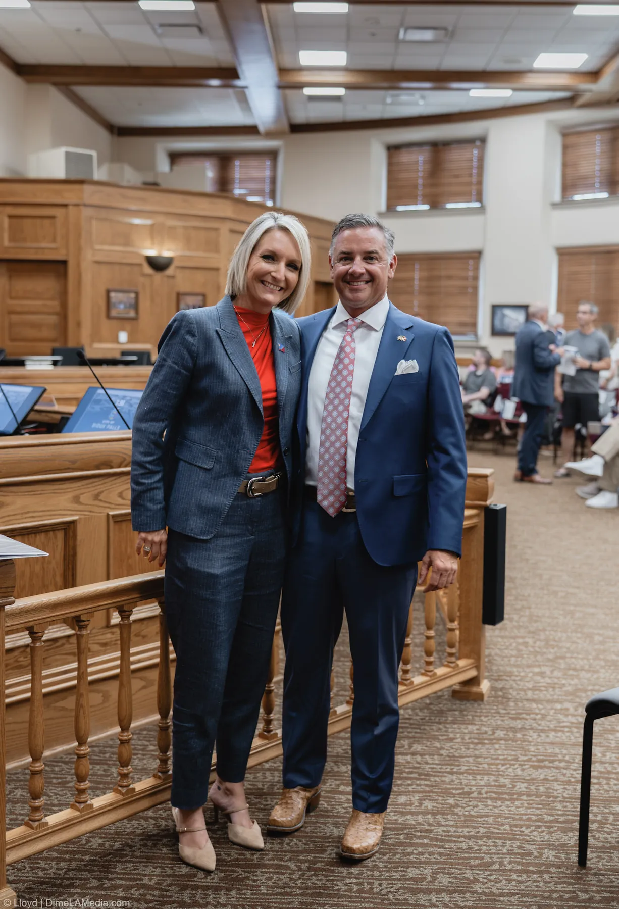 Christine Erickson poses with family inside the council chamber before her inauguration