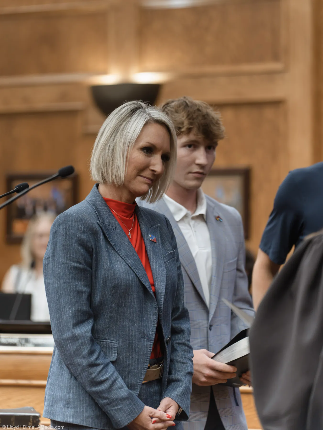 Christine Erickson stands with her son holding the Bible in the moments before the oath