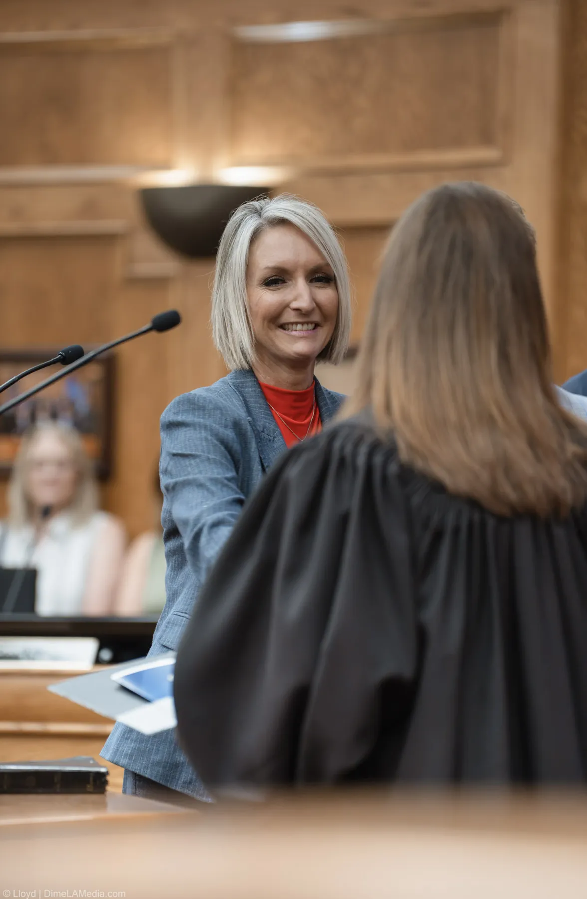 Christine Erickson beams at the presiding judge just after completing the oath of office