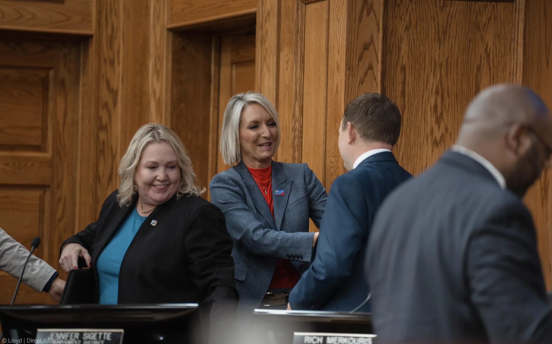 Mayor Christine Erickson greets council members at the dais after taking the oath