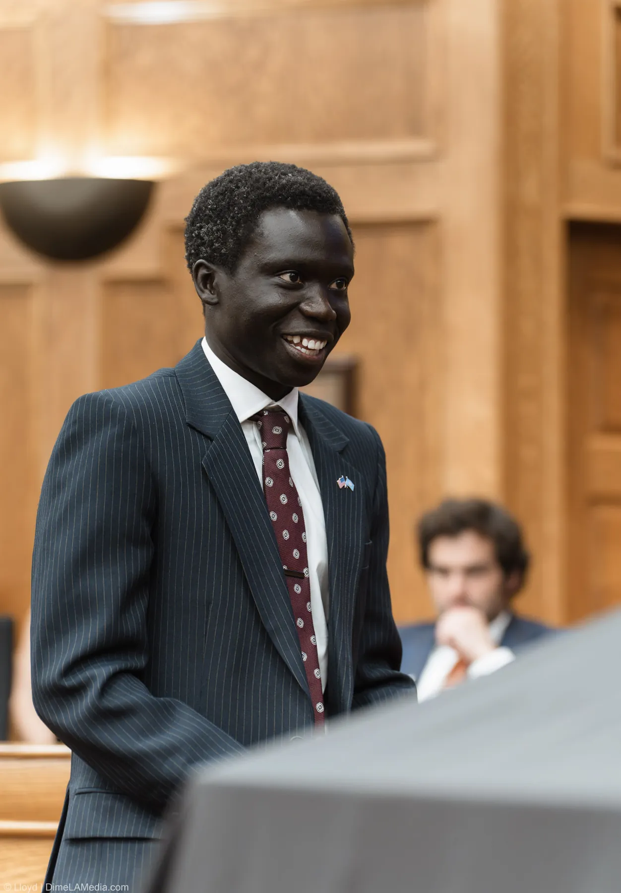 Council member Zak Okuwe smiles in the chamber before taking the oath of office
