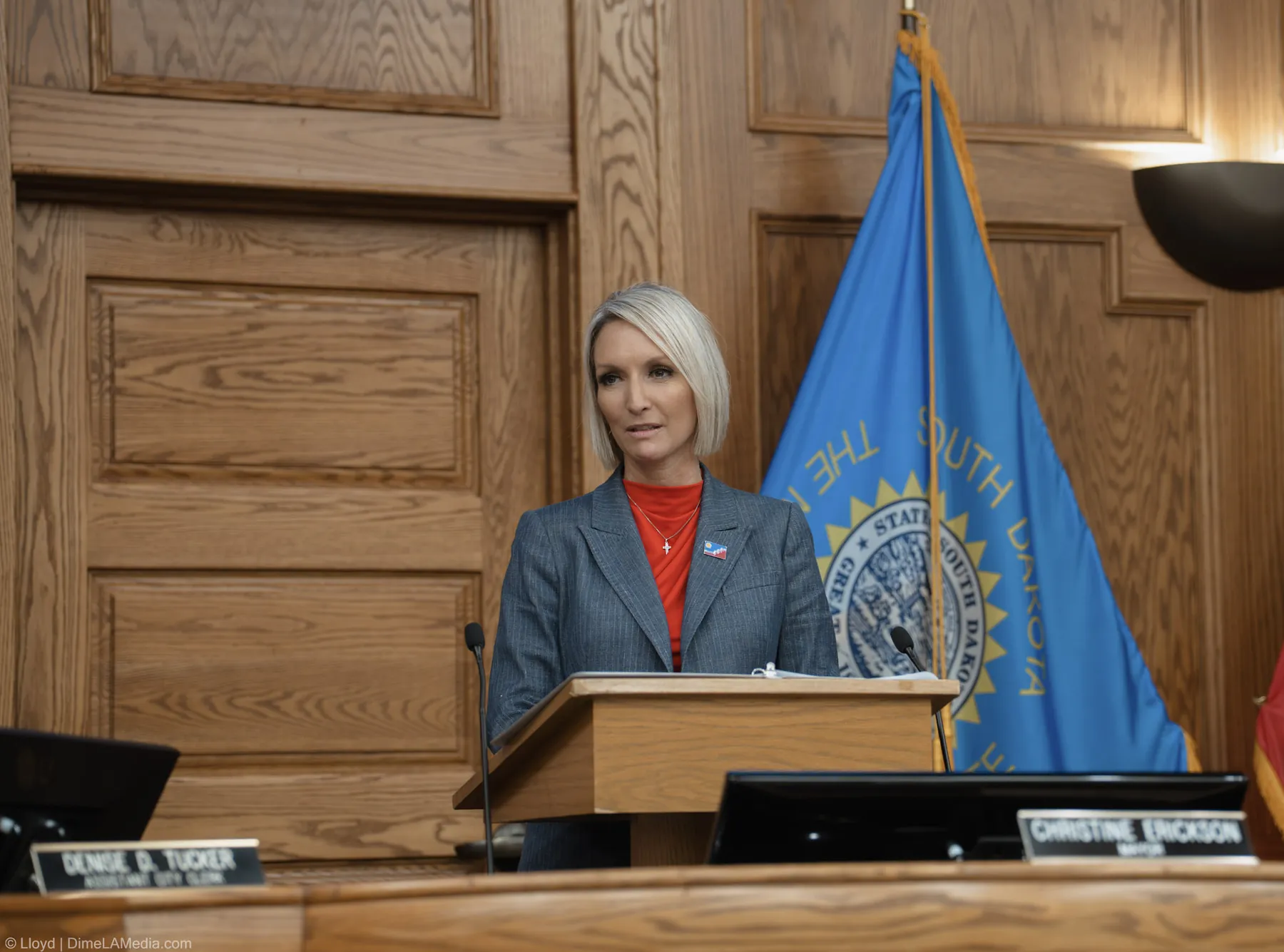 Mayor Christine Erickson addresses the chamber from the podium with her nameplate in the foreground
