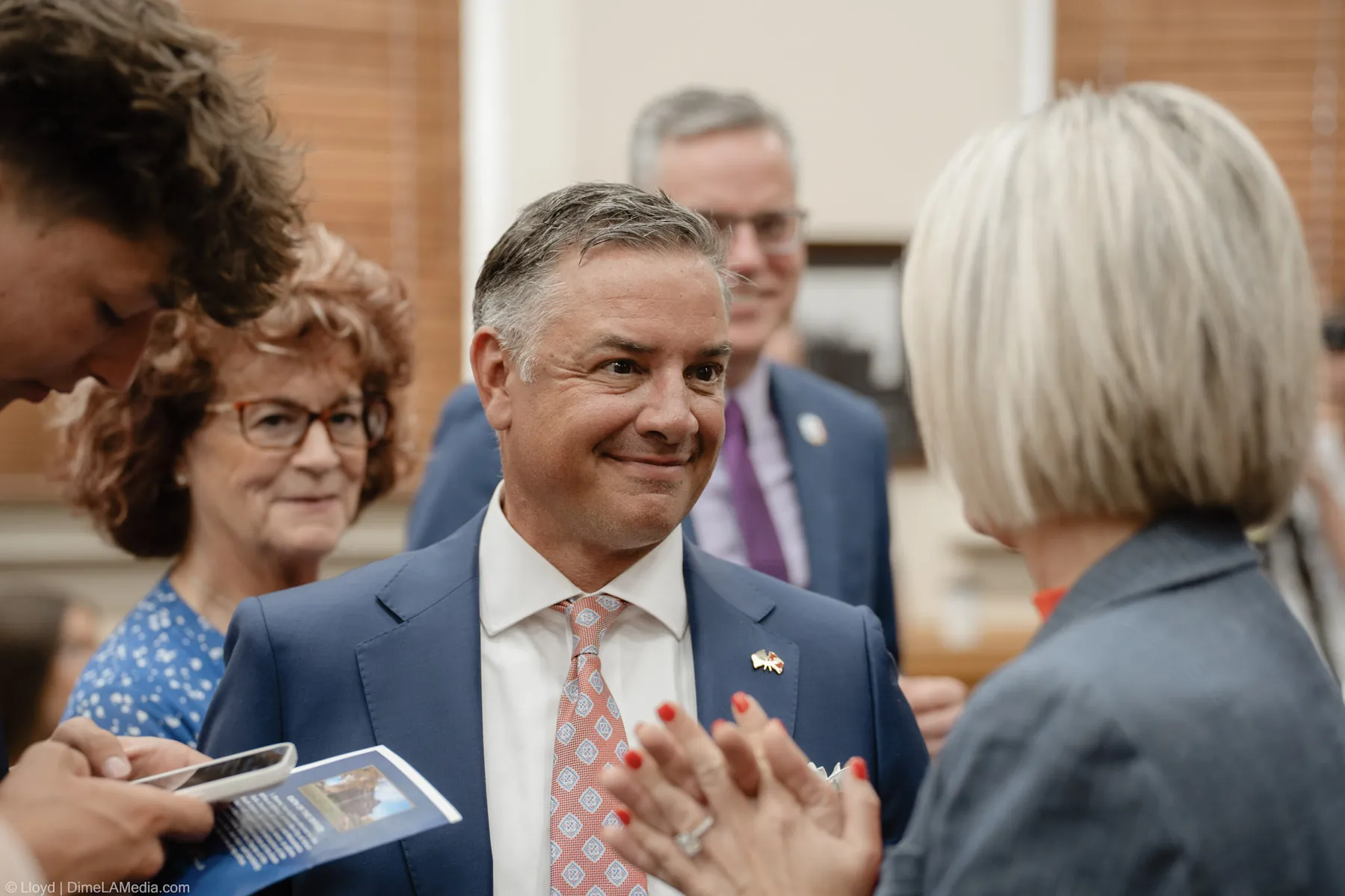 A proud smile in the crowd as Mayor Christine Erickson greets guests after the ceremony