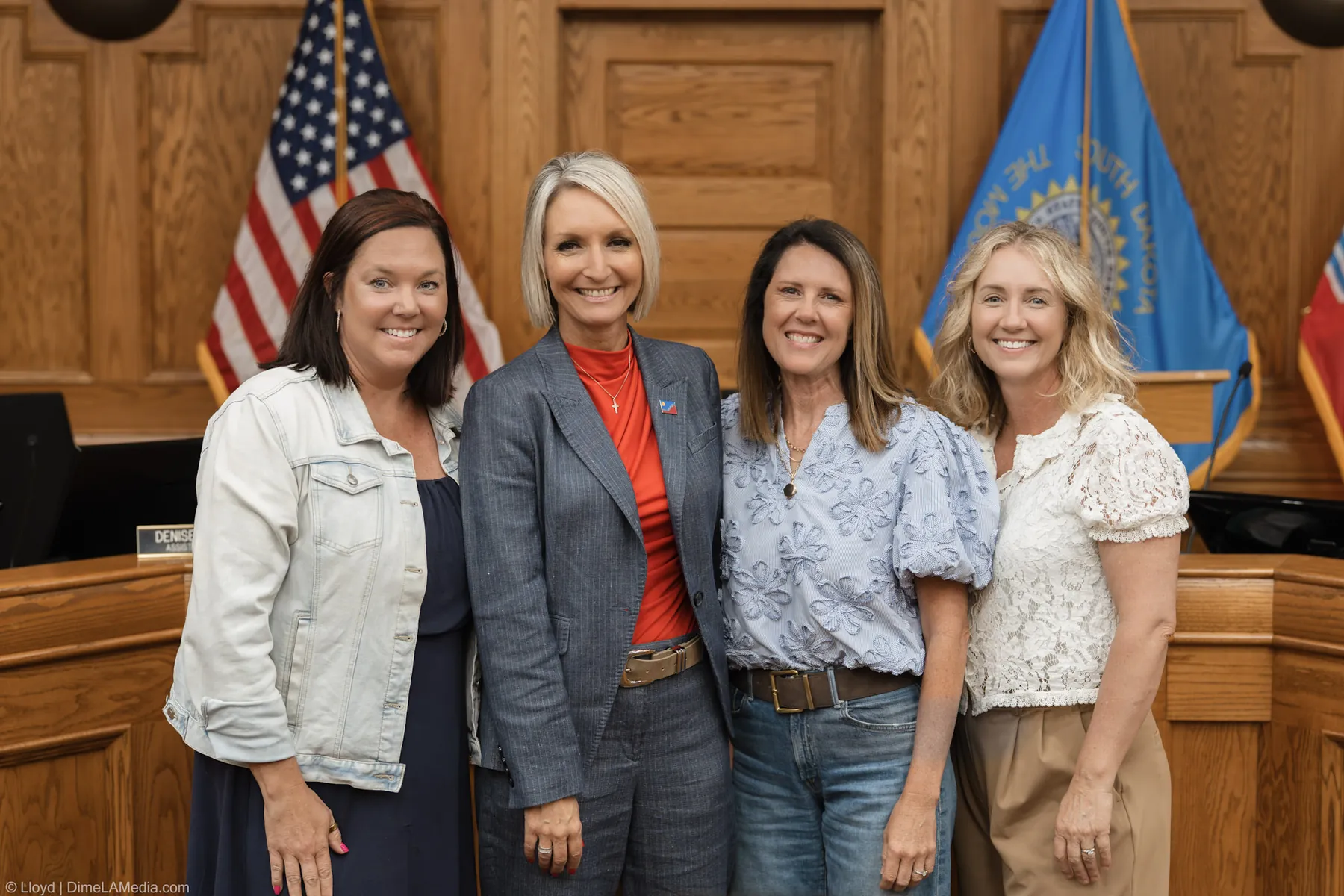 Mayor Christine Erickson with friends in front of the flags after the inauguration