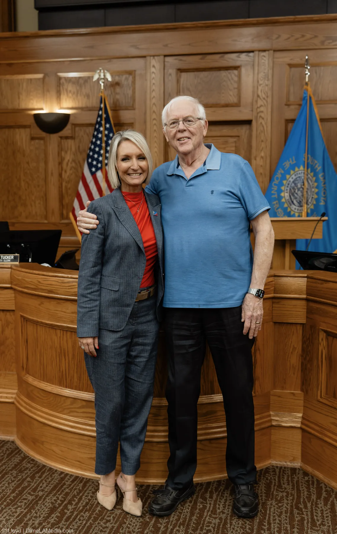 Mayor Christine Erickson poses with a family member beside the dais after the swearing-in