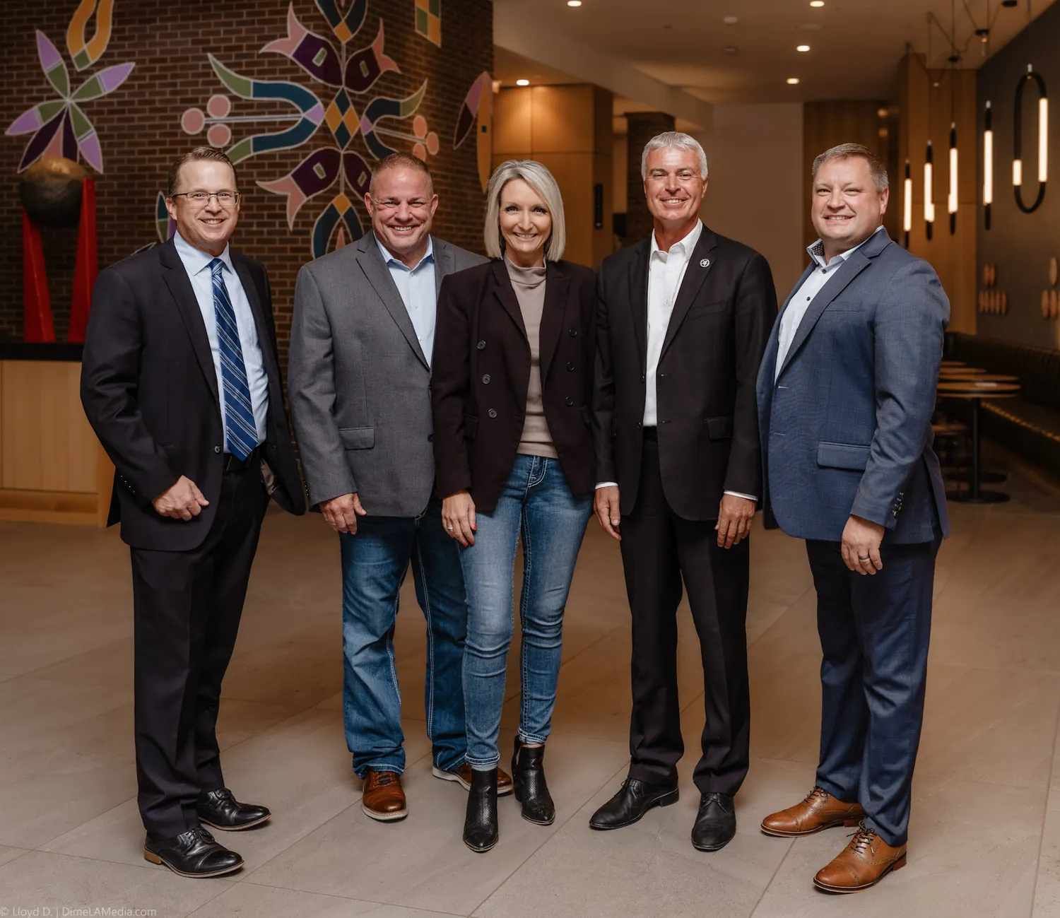 Christine Erickson stands for a portrait with state and city leaders, including South Dakota Attorney General Marty Jackley, during her mayoral campaign