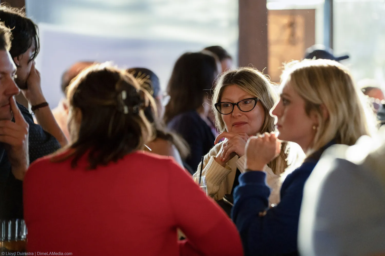 Guests in conversation by the windows at the Christine Erickson election night party