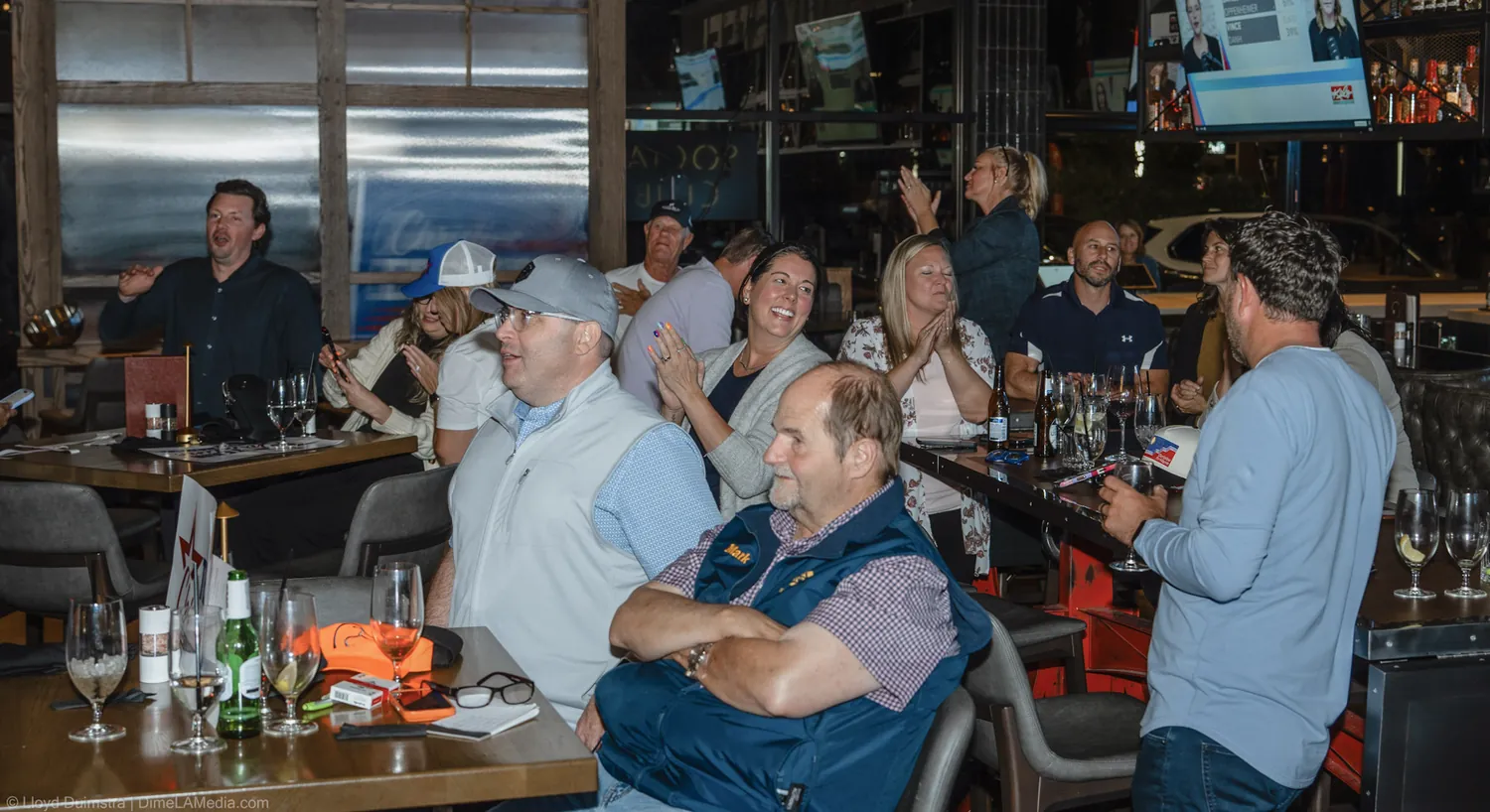 Wide view of the crowd cheering the election results at the Christine Erickson party