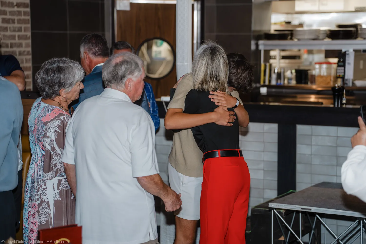Christine Erickson hugs family members after winning the election