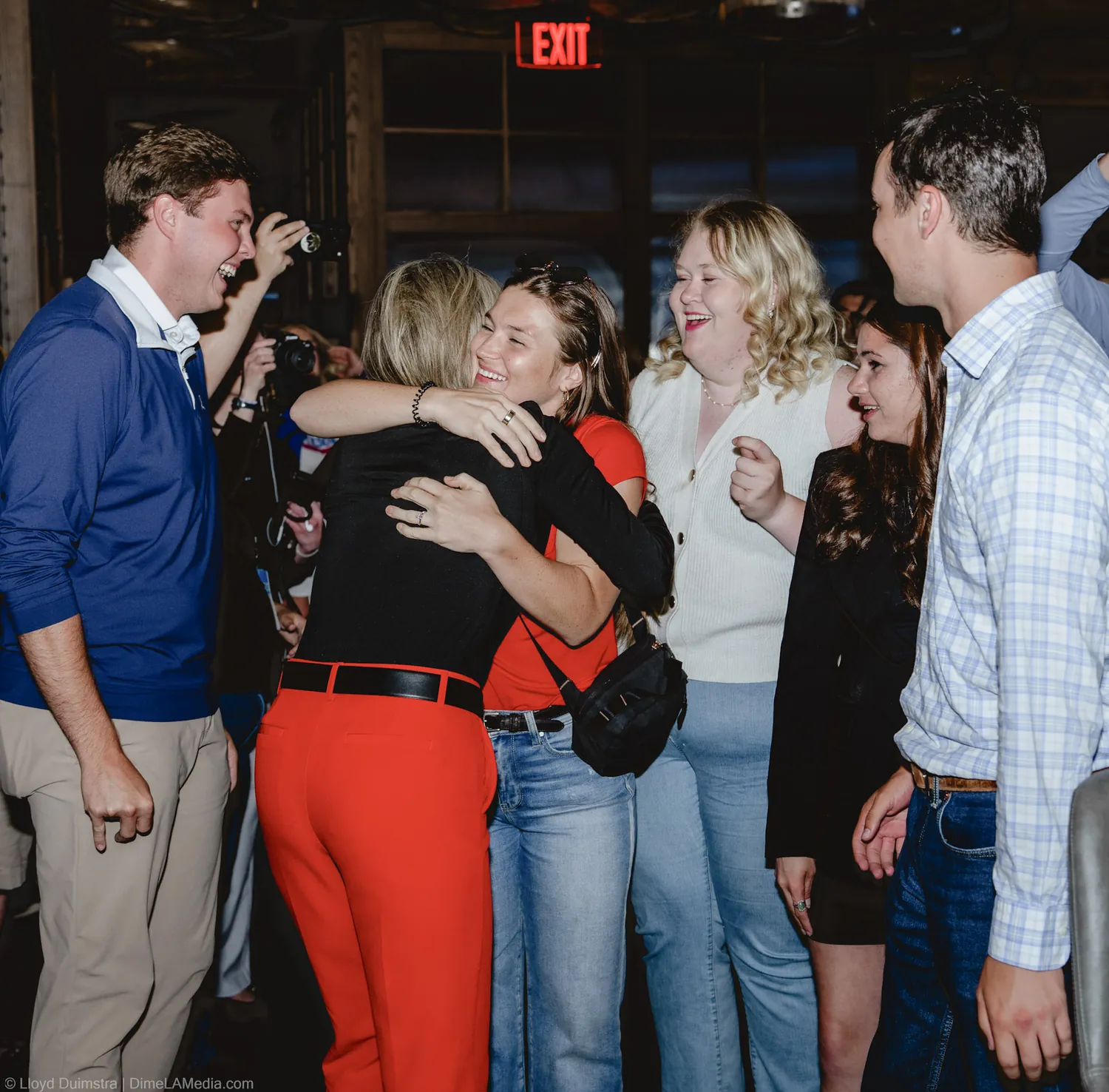 Christine Erickson shares a group hug with young supporters at the victory party
