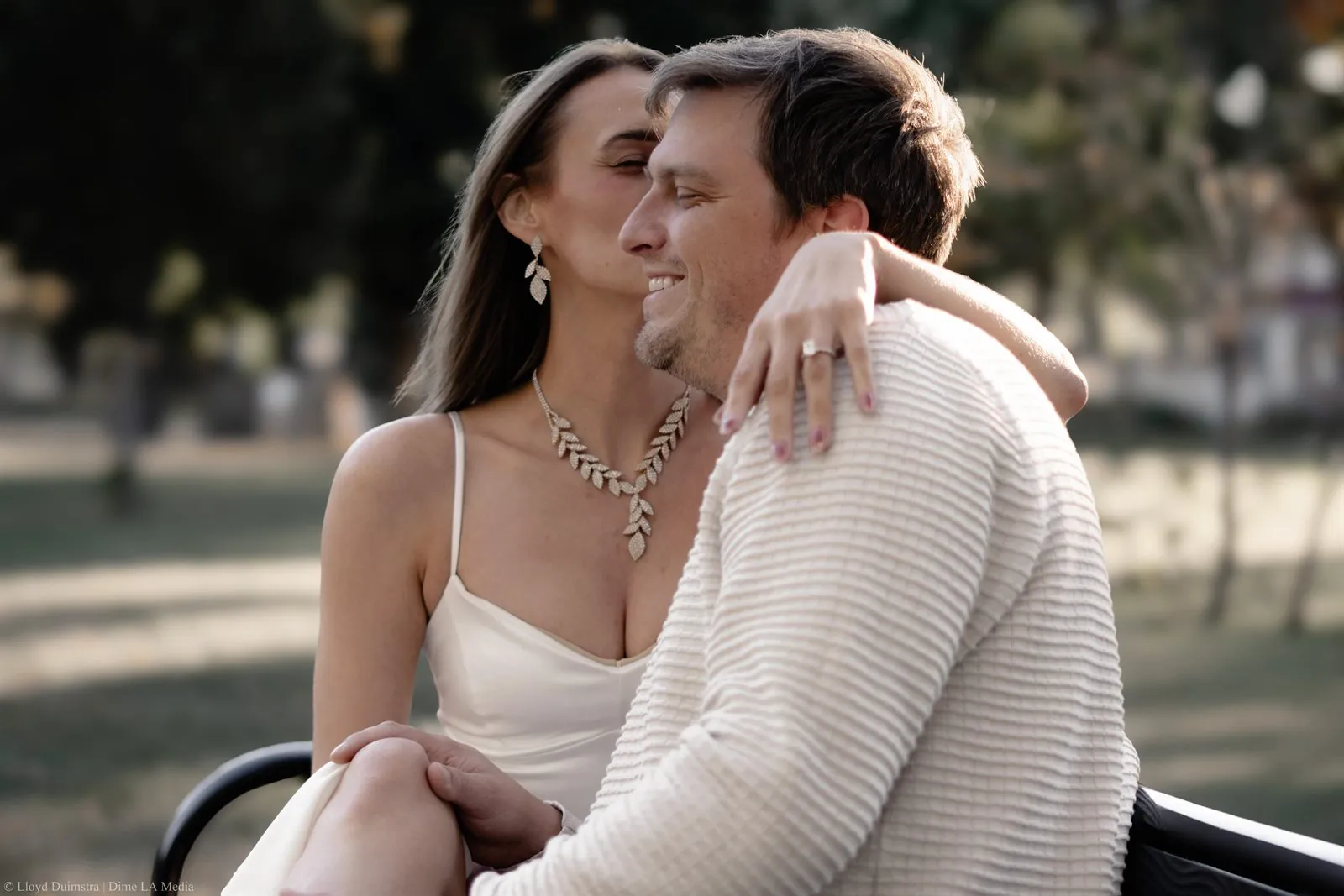 Close portrait of an engaged couple embracing at golden hour