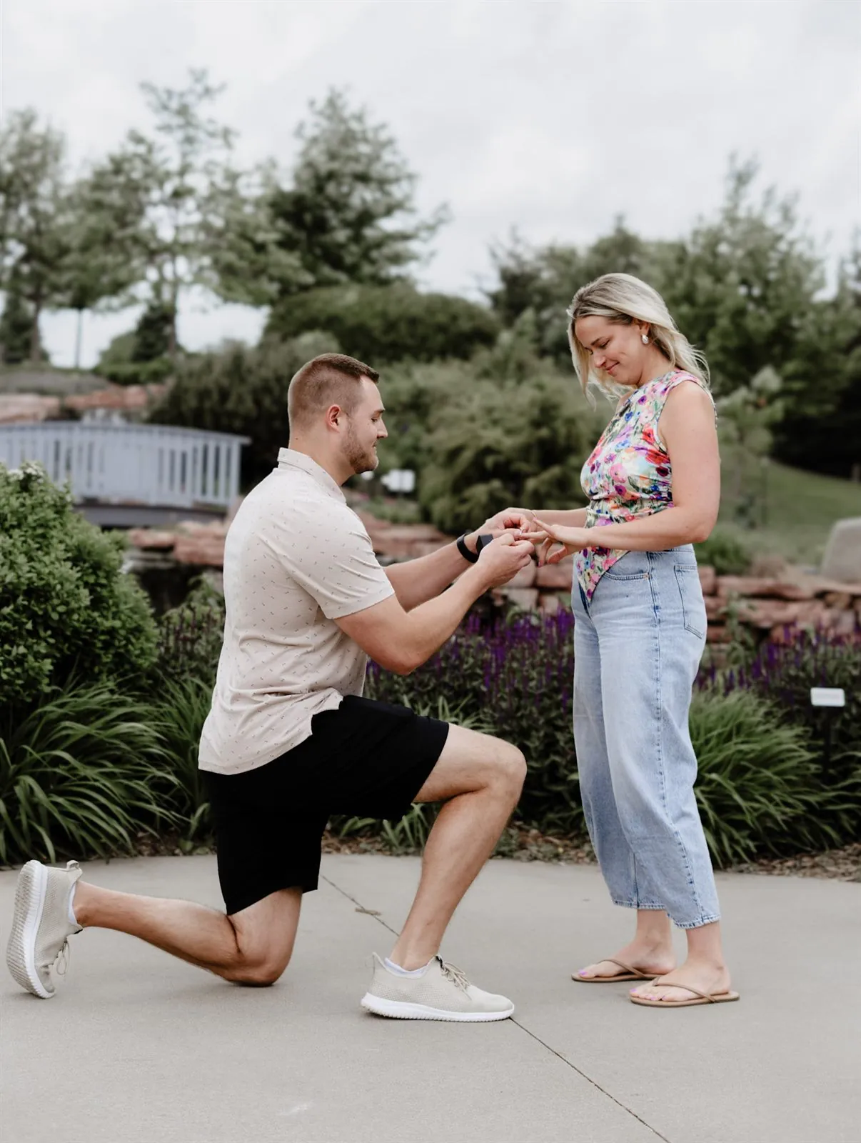 Man on one knee proposing in a garden