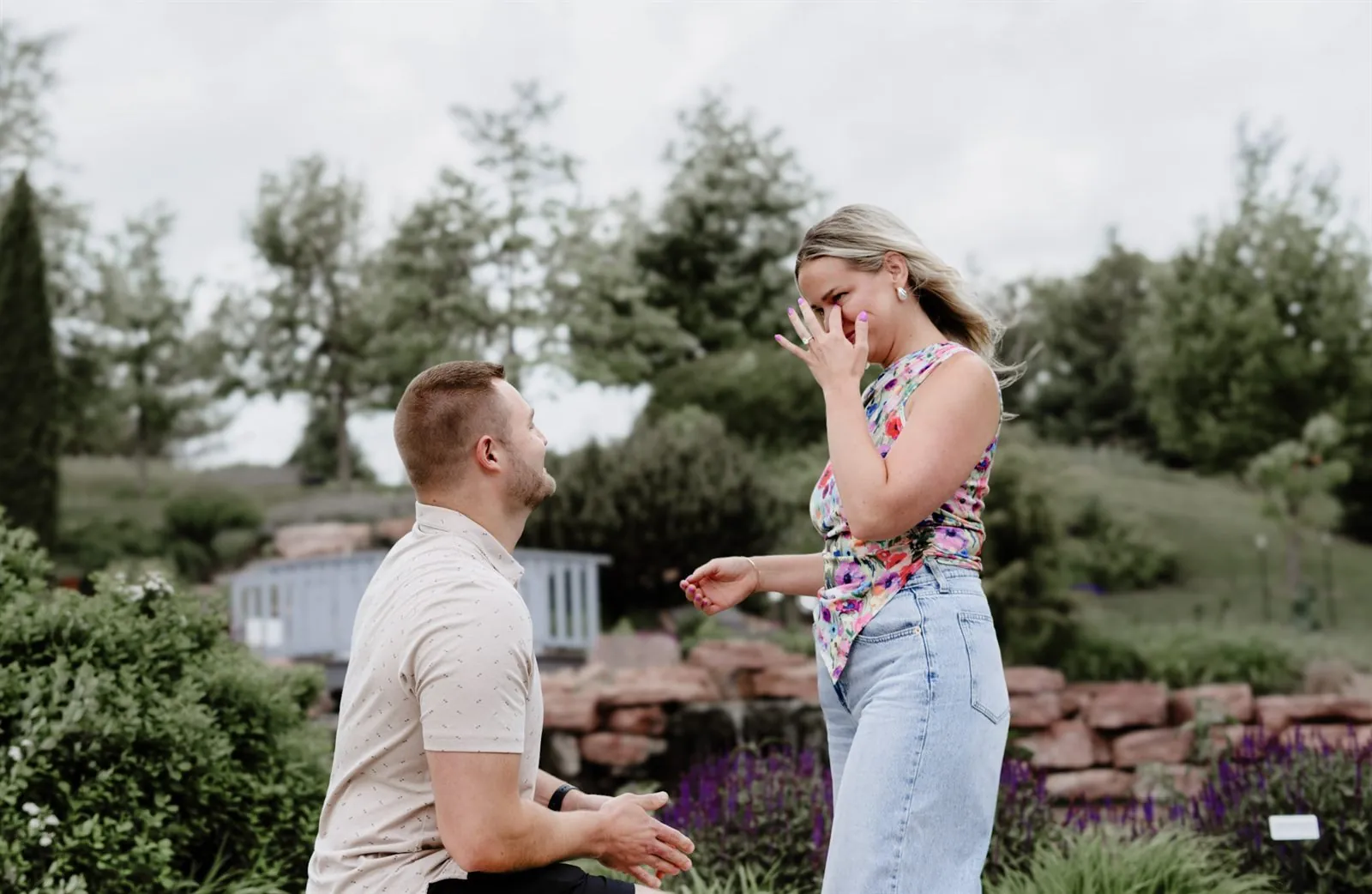 Newly engaged woman wiping happy tears after the proposal