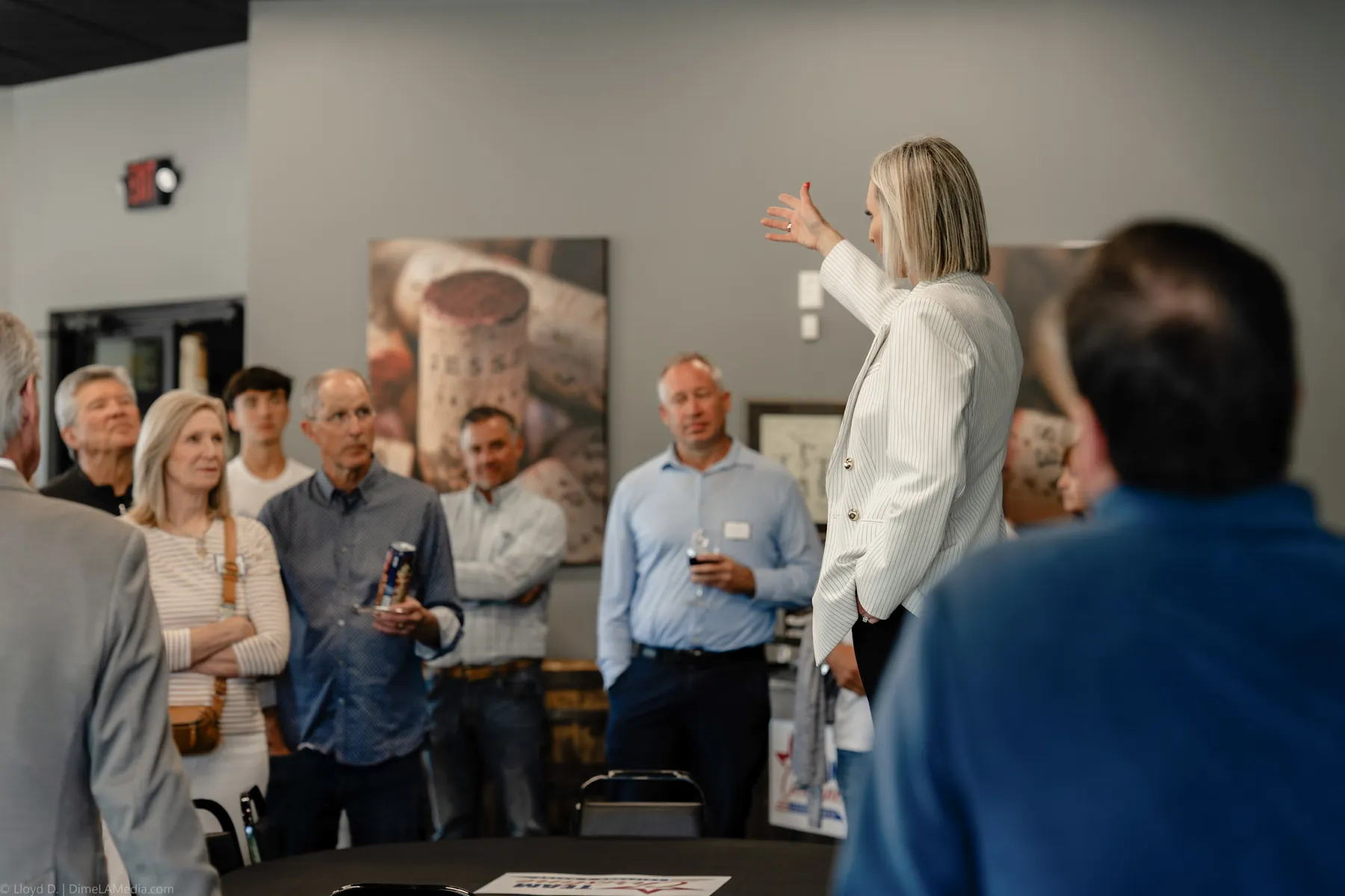 Speaker gesturing while addressing guests at a Sioux Falls venue
