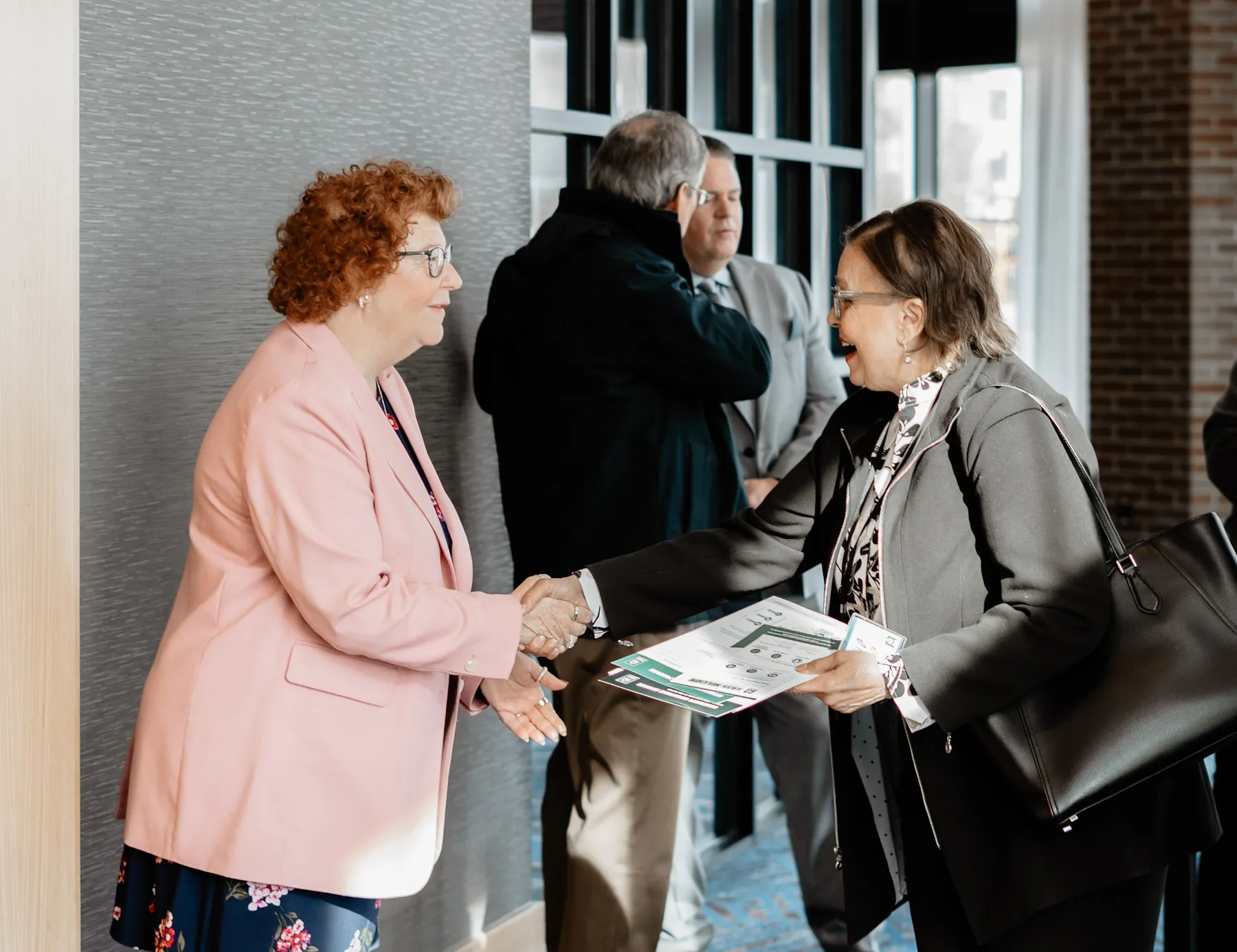 Business professionals shaking hands at a Sioux Falls corporate event