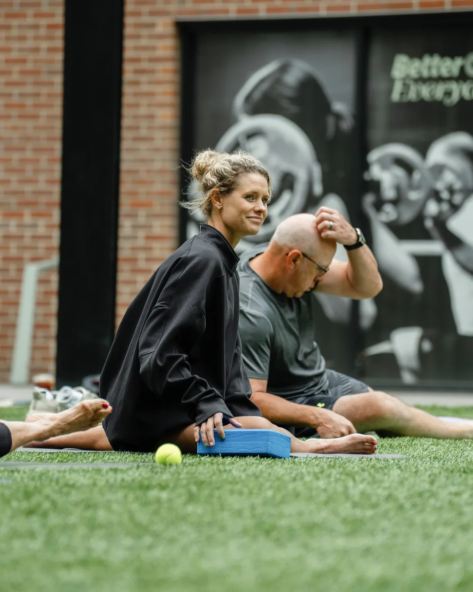 Two participants laughing between rounds at the Sisu and Pomegranate Market Kinstretch class, Sioux Falls SD