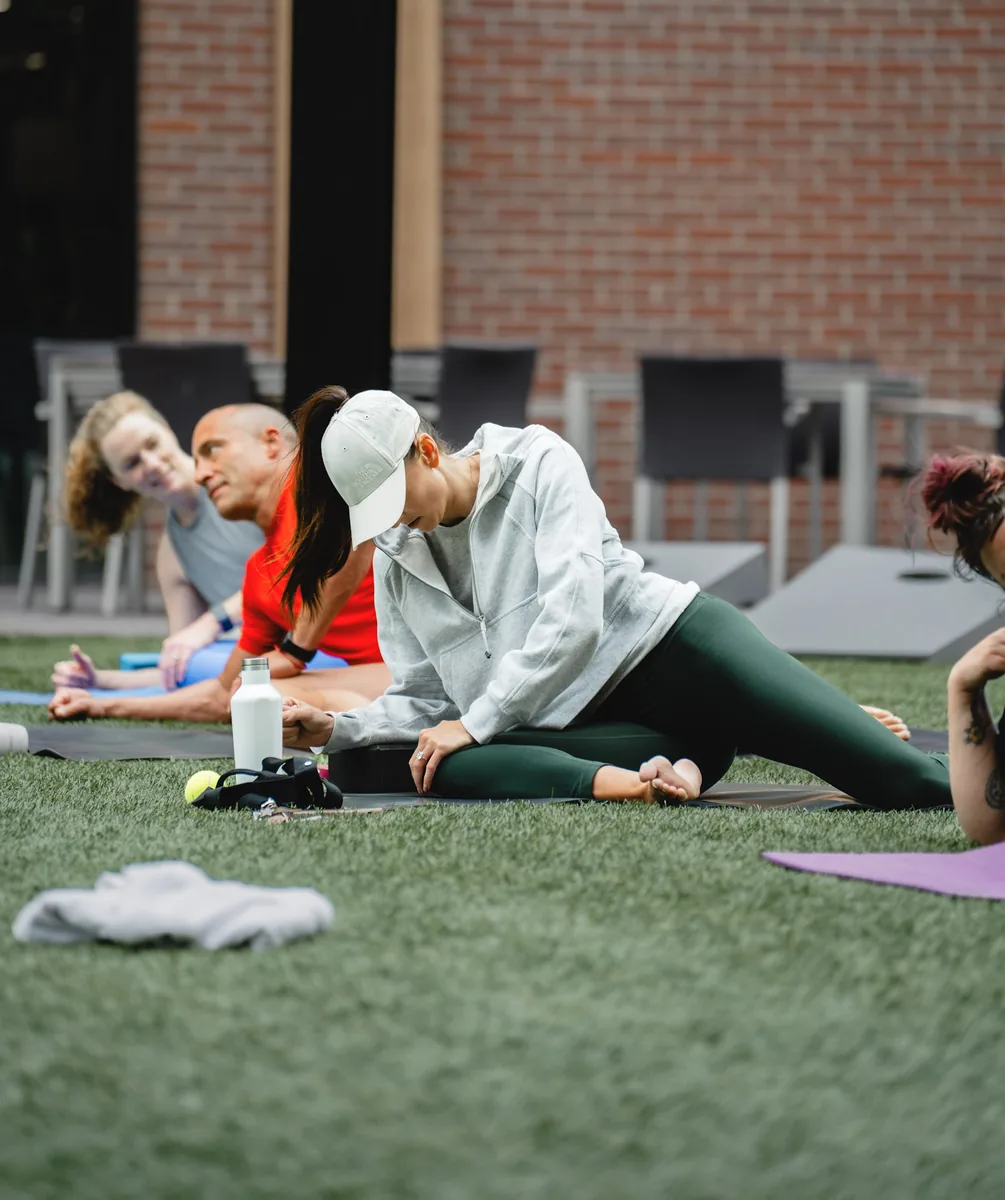 Outdoor Kinstretch class hosted by Sisu and Pomegranate Market, photographed by Lloyd Duimstra at Cherapa Place in downtown Sioux Falls SD