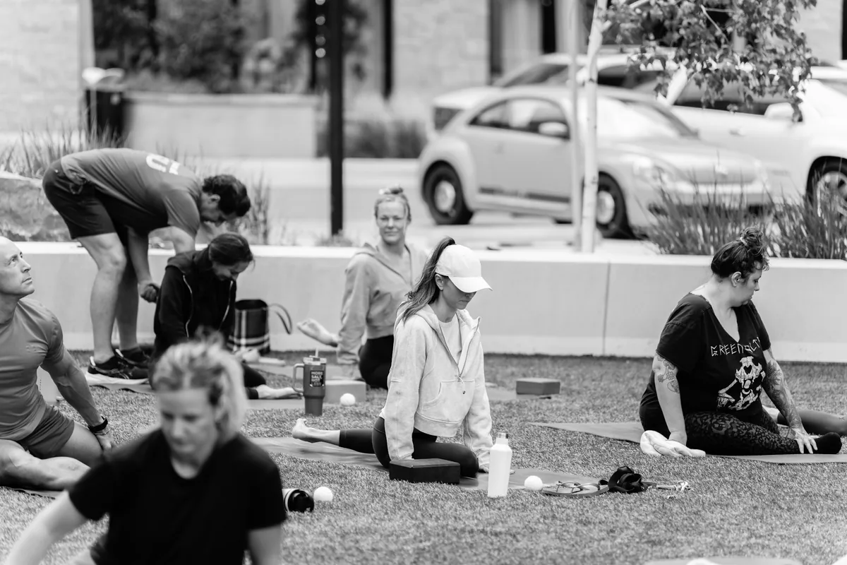 Outdoor Kinstretch class hosted by Sisu and Pomegranate Market, photographed by Lloyd Duimstra at Cherapa Place in downtown Sioux Falls SD