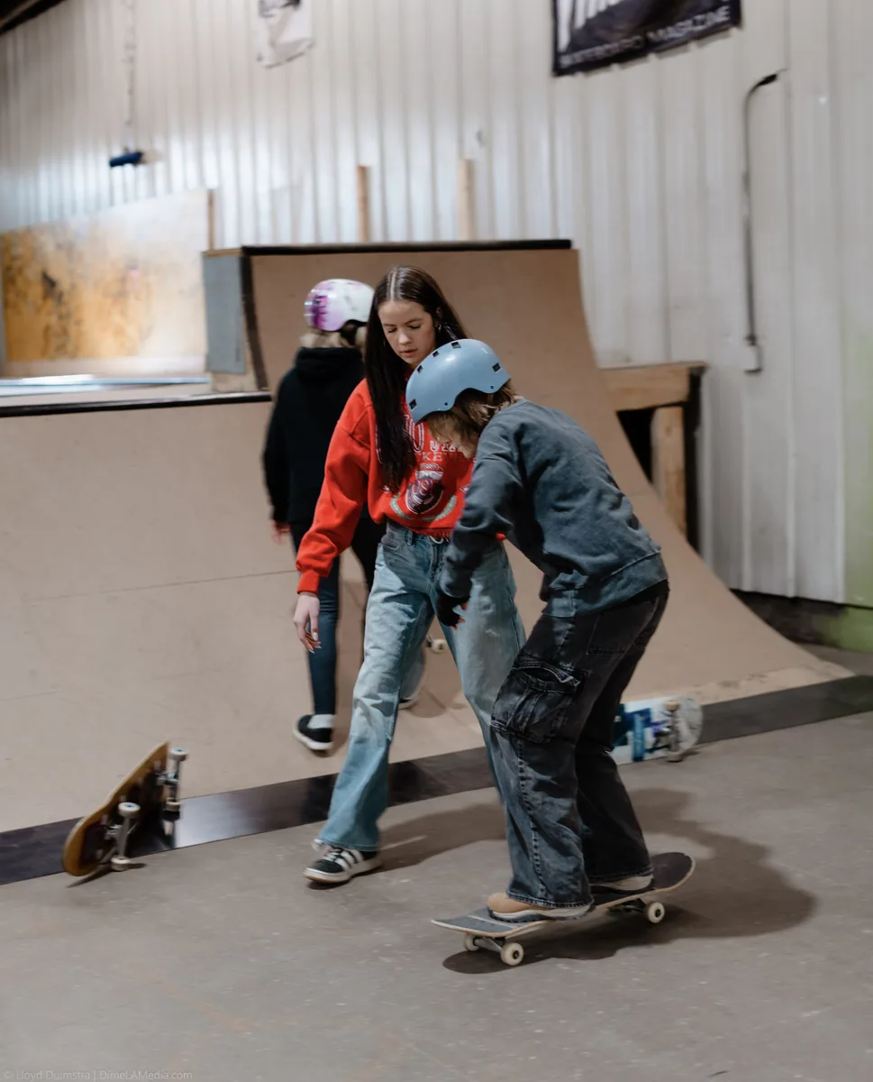 A young skater rolling across the flat at The Siouxer indoor skatepark in Sioux Falls SD