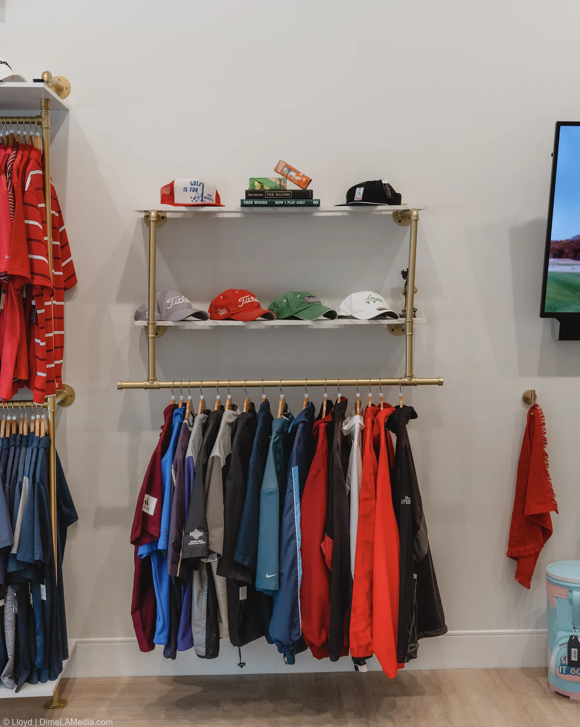 A wall of red, white, and navy golf apparel hanging at Final Drive