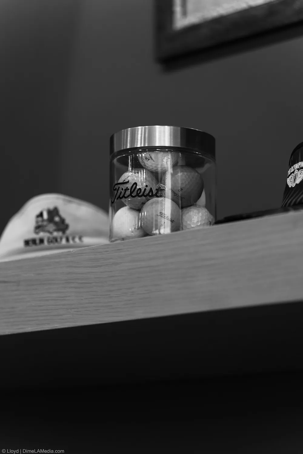 Black and white detail of a Titleist golf ball tin on the shelf at Final Drive