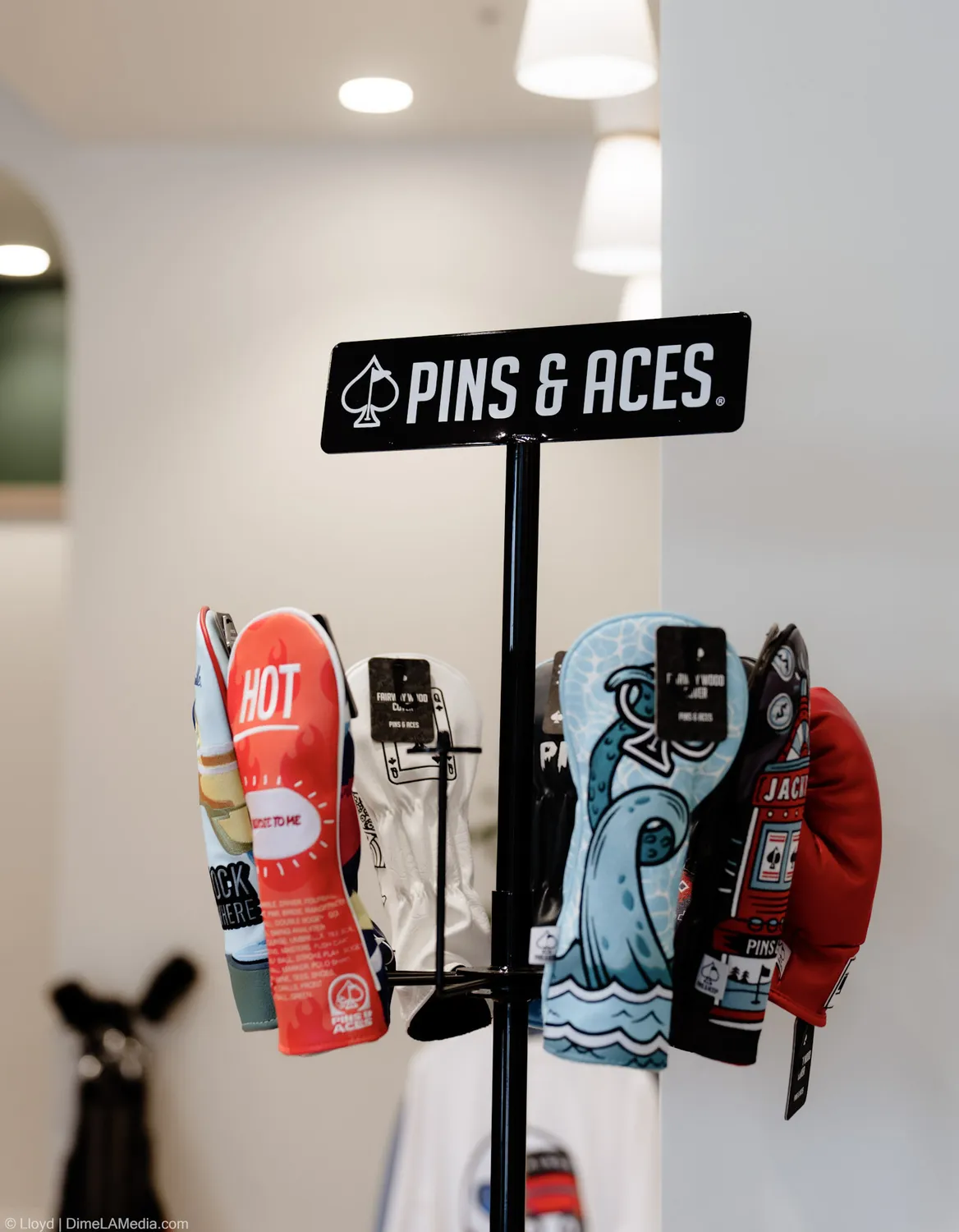 Pins and Aces headcover display stand at Final Drive golf shop