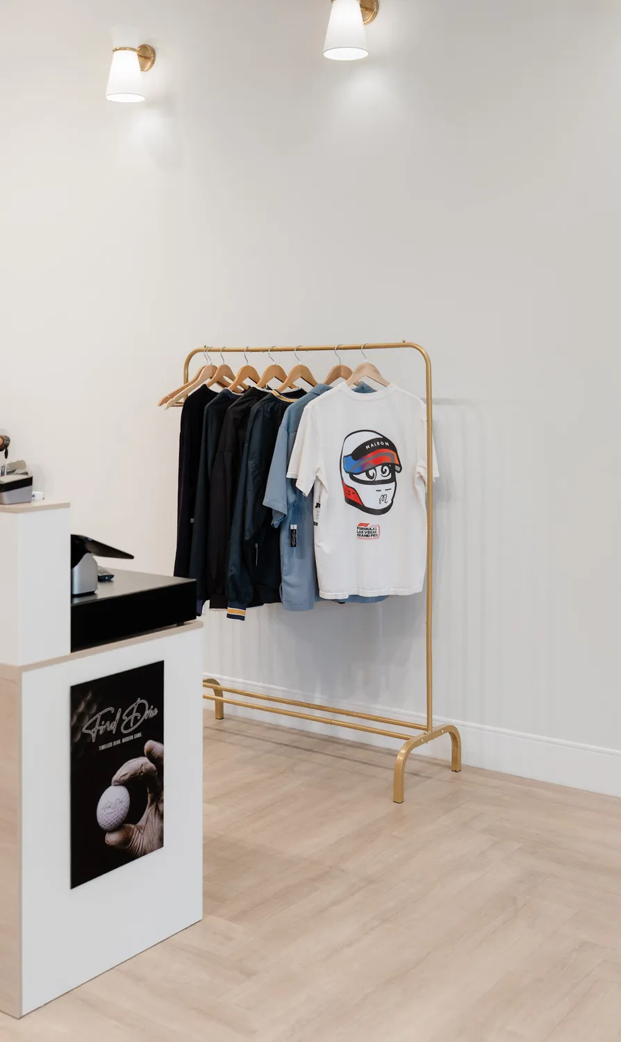 Apparel rack and framed artwork by the counter at Final Drive golf shop in Sioux Falls