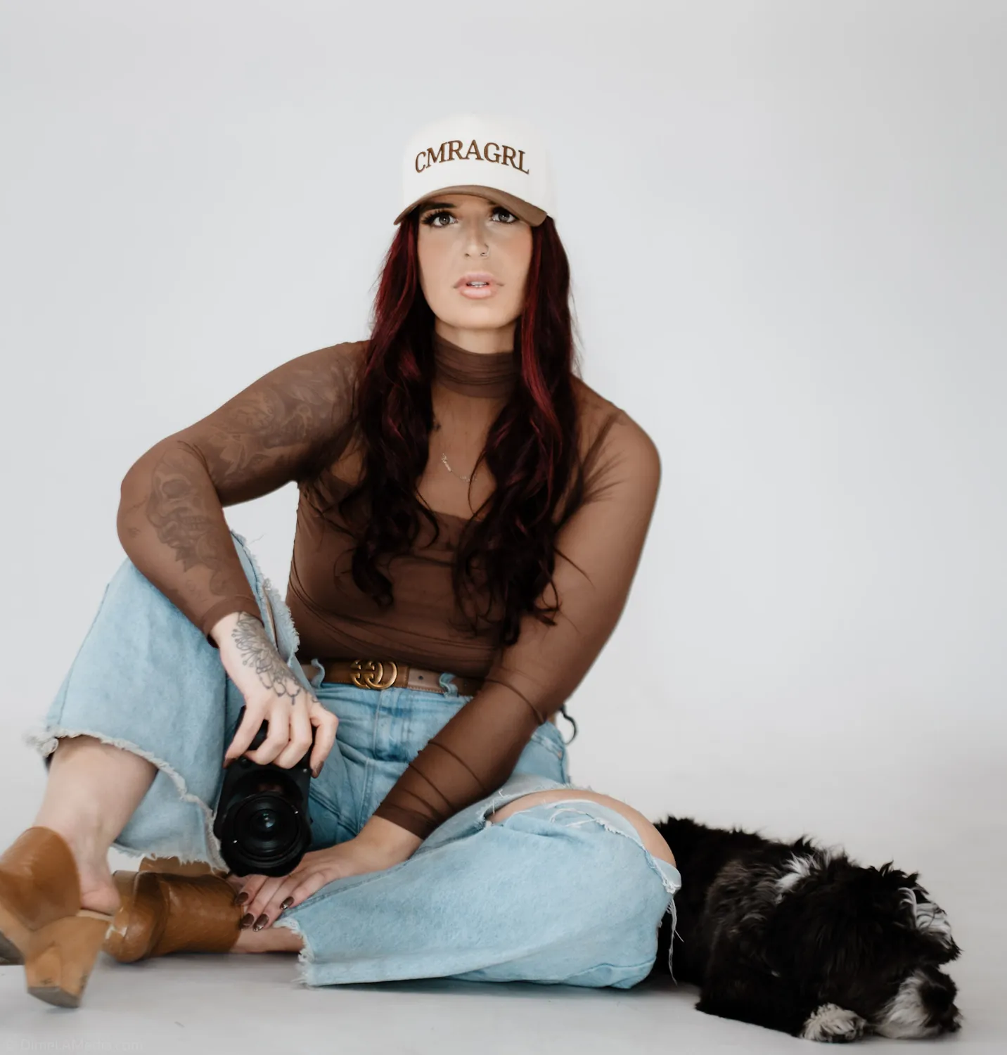 Jade looks up from the studio floor with her dog resting at her side