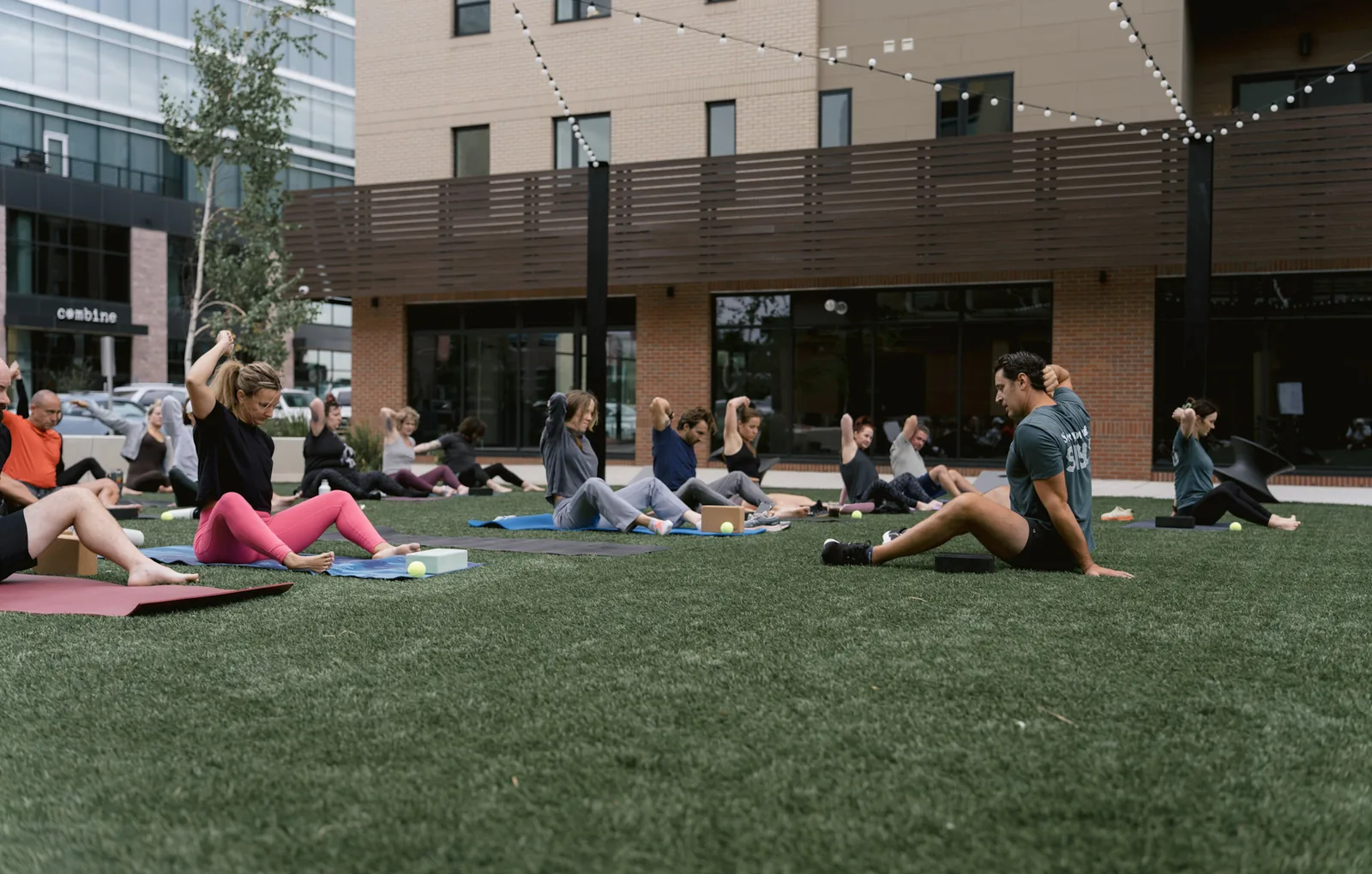 The Kinstretch class spread across the lawn at Cherapa Place under the string lights, Sioux Falls SD