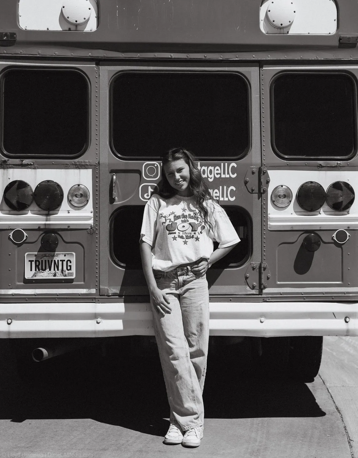 Black and white portrait of Maddie Theisen in front of the True Vintage bus back doors