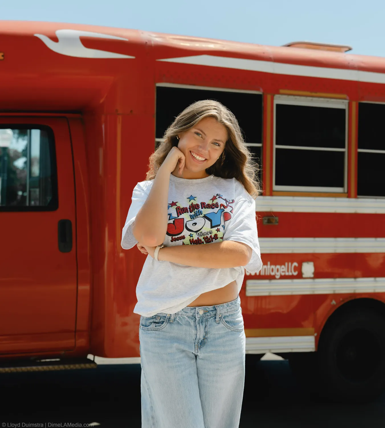 Portrait of Maddie Theisen smiling beside the True Vintage bus in Sioux Falls