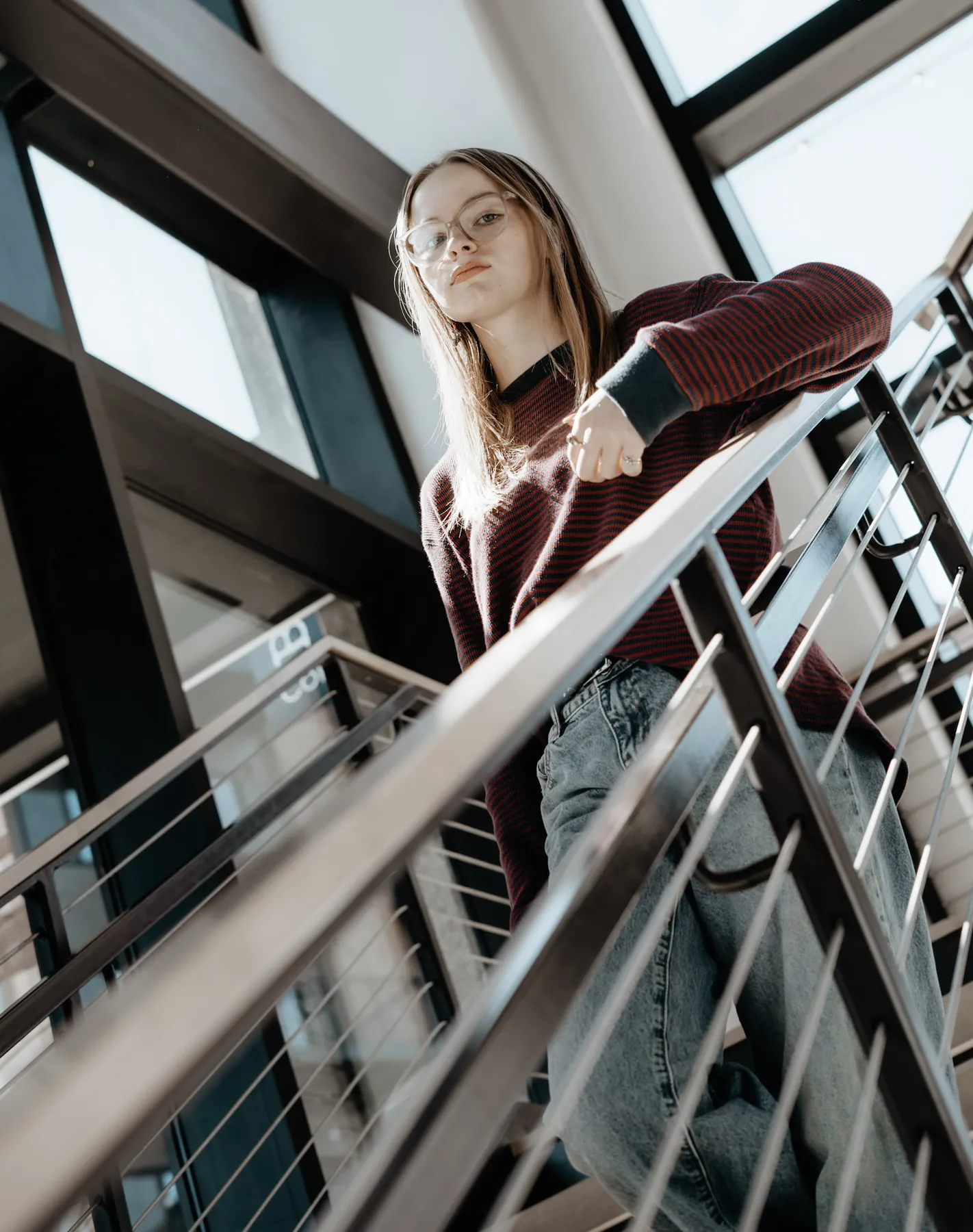 Syd Patzwald senior portrait leaning over a staircase railing