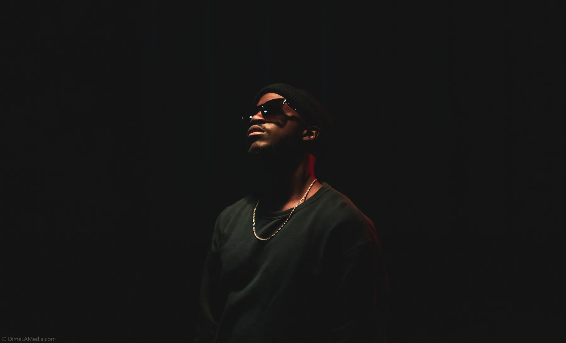 Low-key studio portrait with red accent lighting