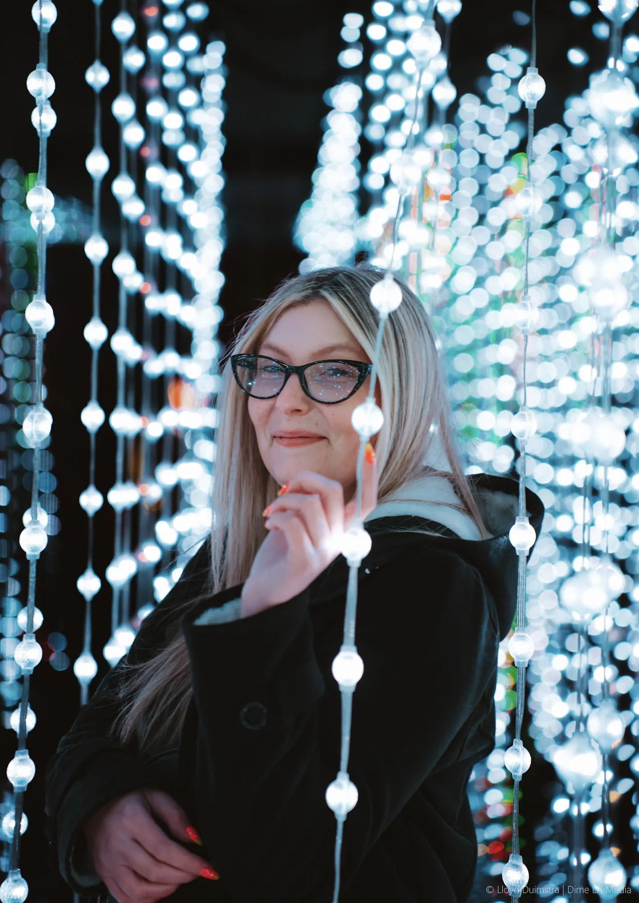 Portrait framed by curtains of string lights