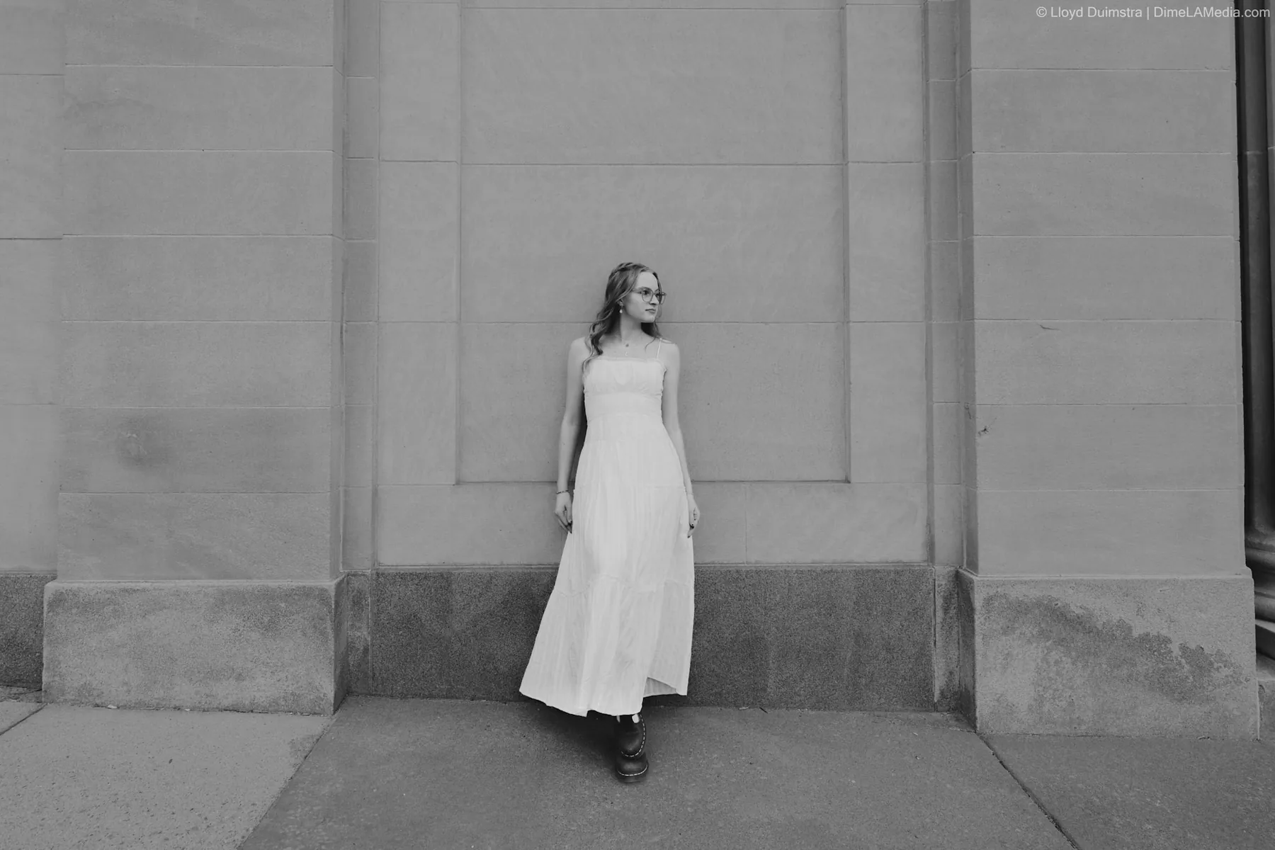 Editorial portrait in a white dress against stone architecture, Sioux Falls SD