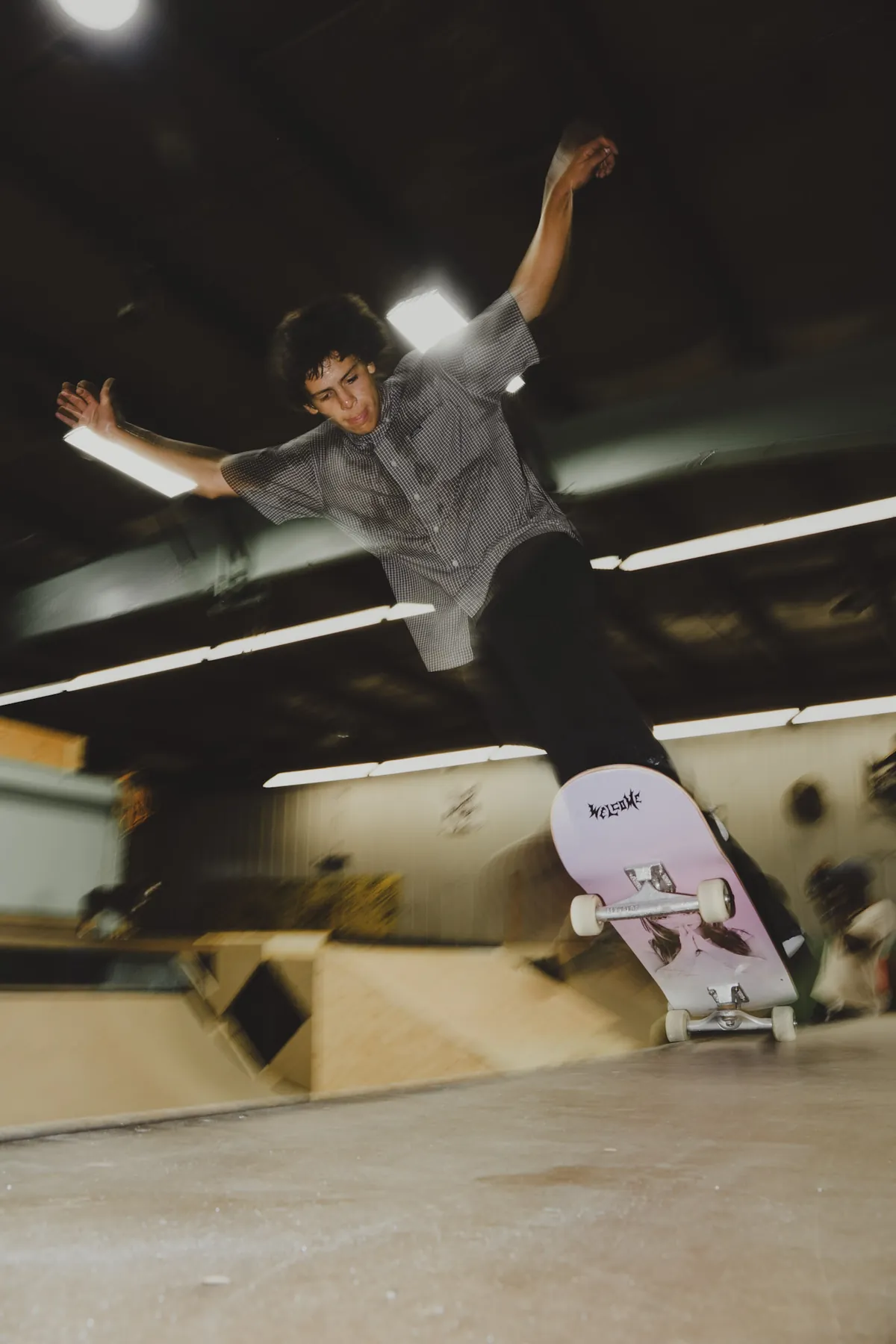 Skater mid-air over the indoor ramp