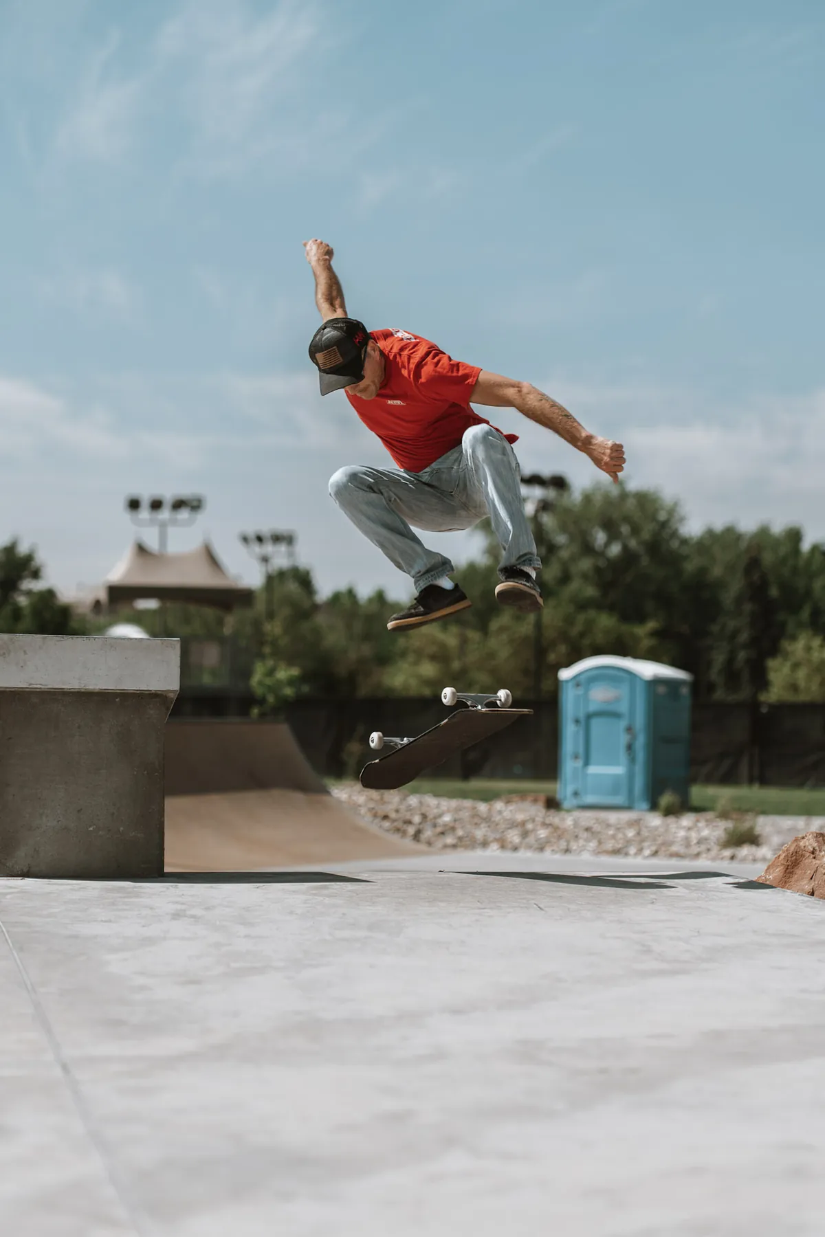 Skateboarder popping off the ledge under streetlights