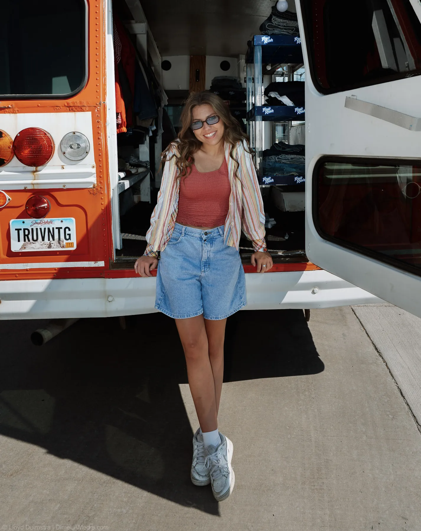 Maddie standing at the open back door of her mobile vintage shop