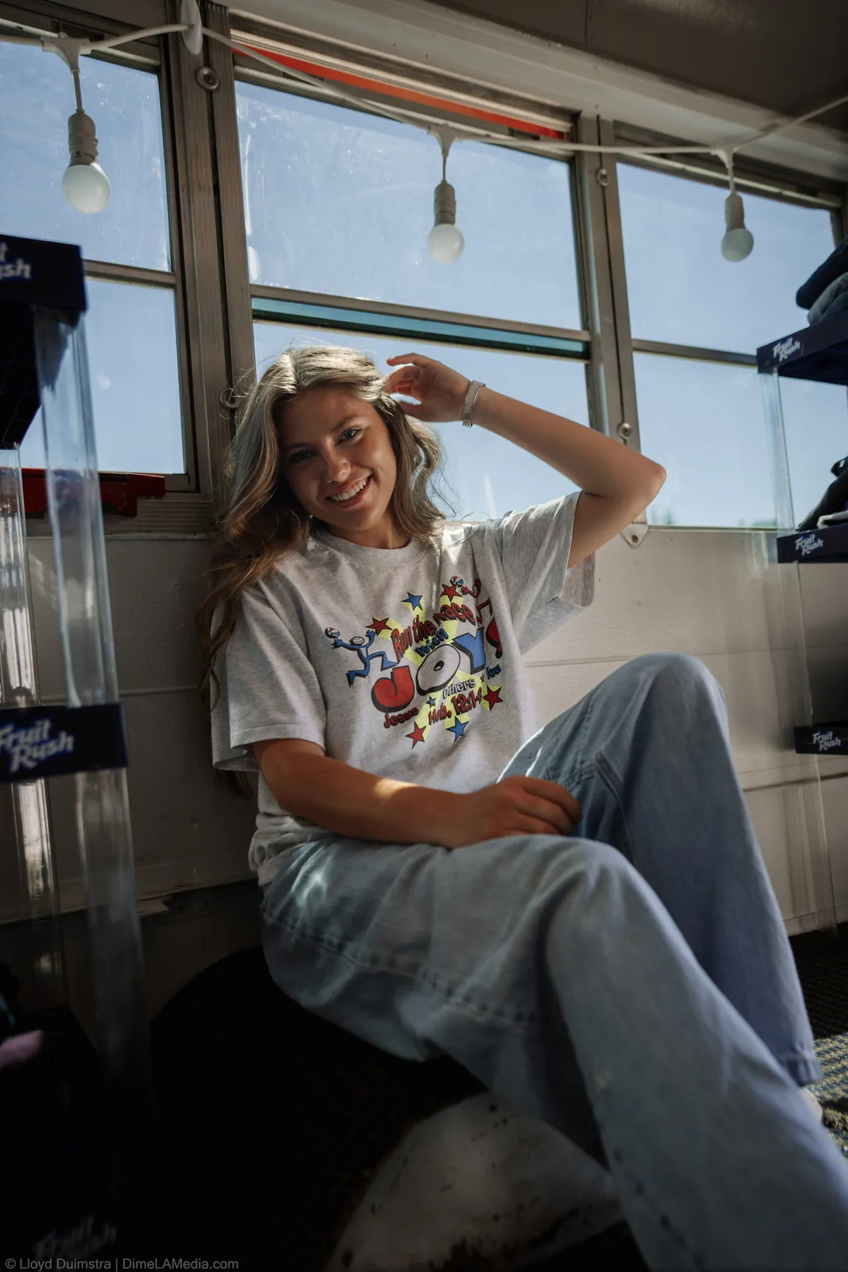 Maddie relaxing on the window bench of her vintage clothing bus
