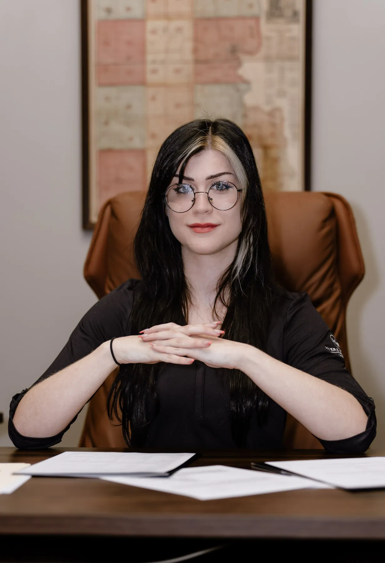 Environmental business portrait of a legal assistant at her desk, Sioux Falls law office