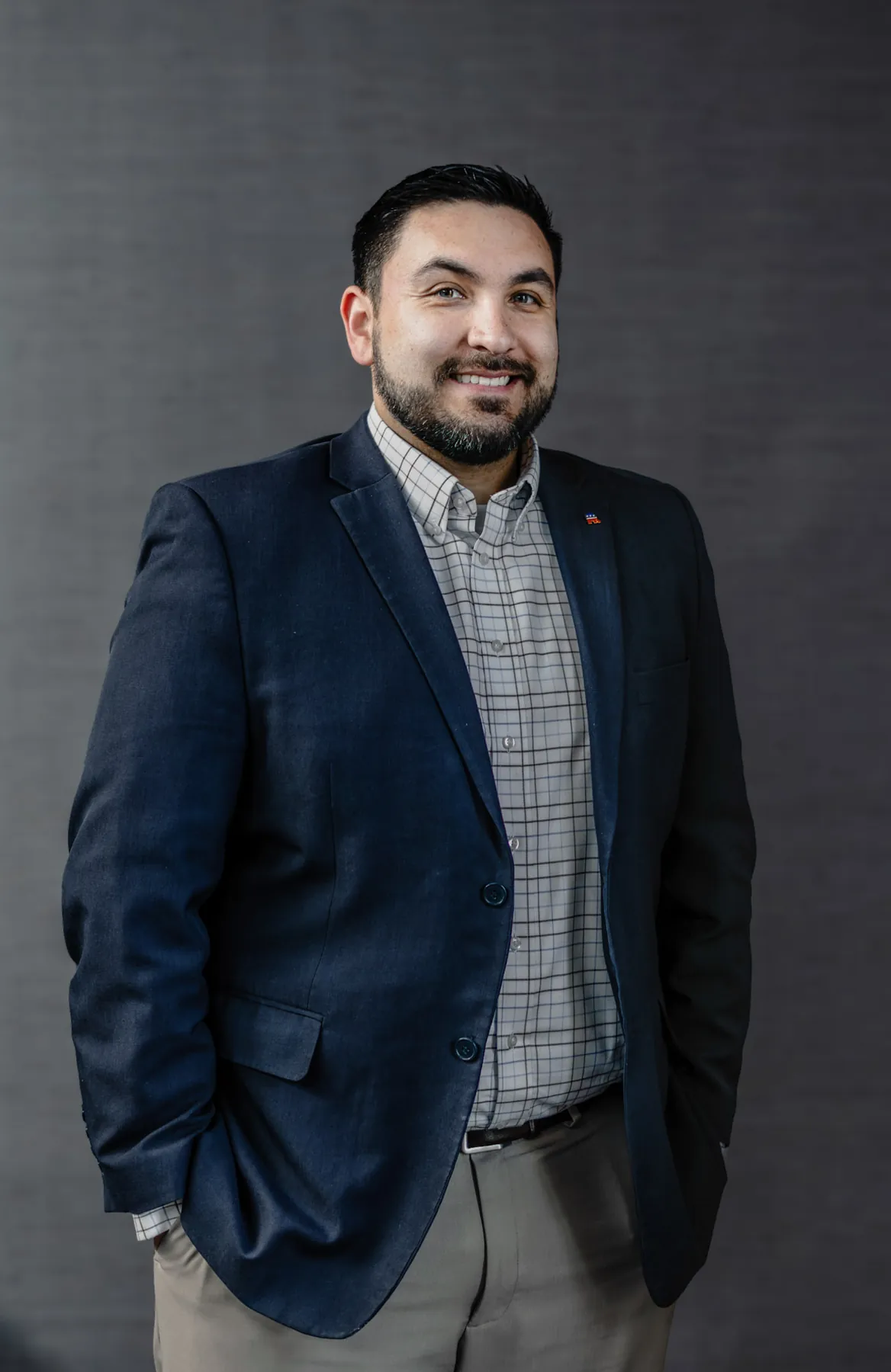 Business portrait of a man in a dark blazer against a textured backdrop, Sioux Falls SD