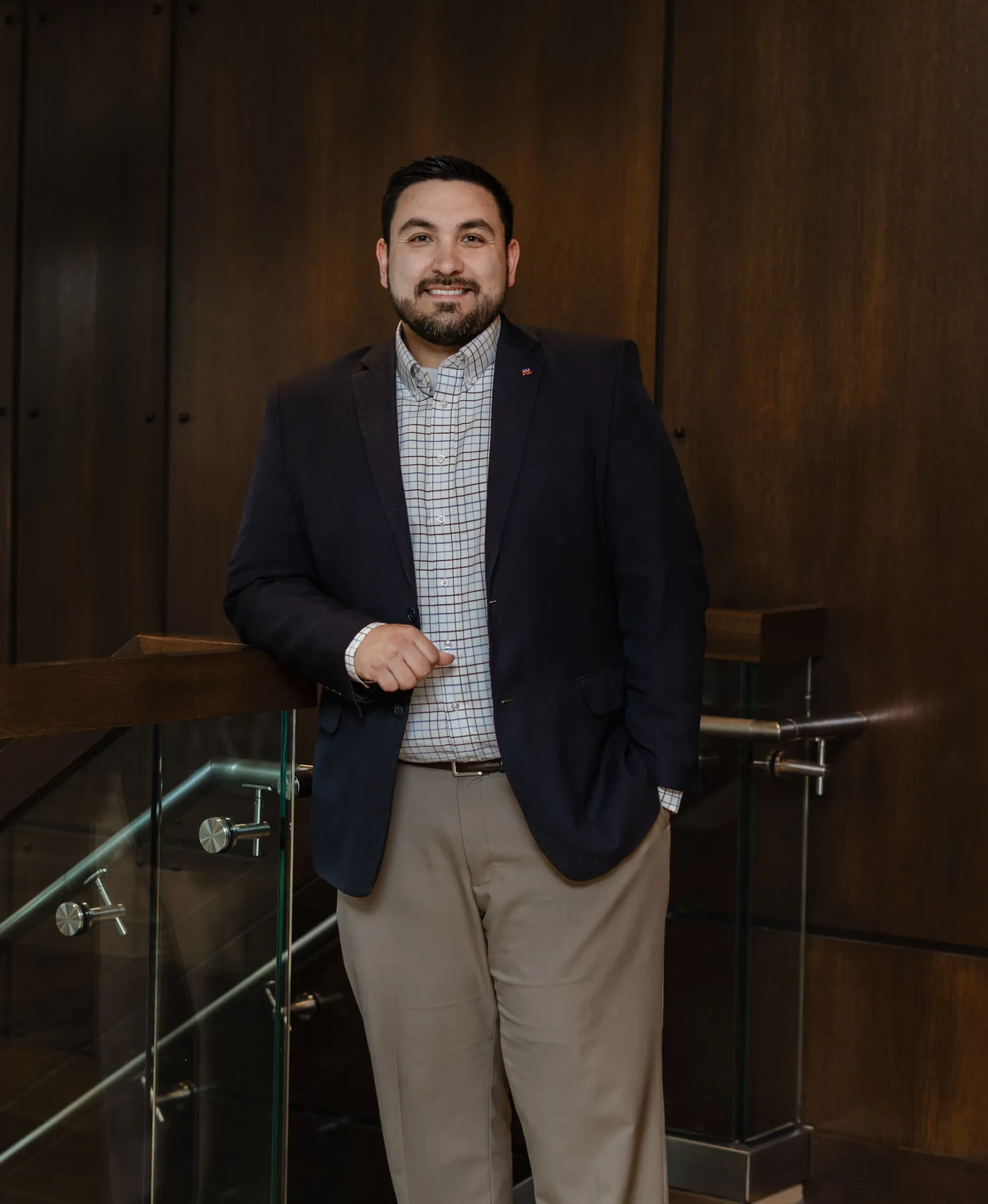 Tyler Tordsen standing portrait on an office staircase, Sioux Falls SD