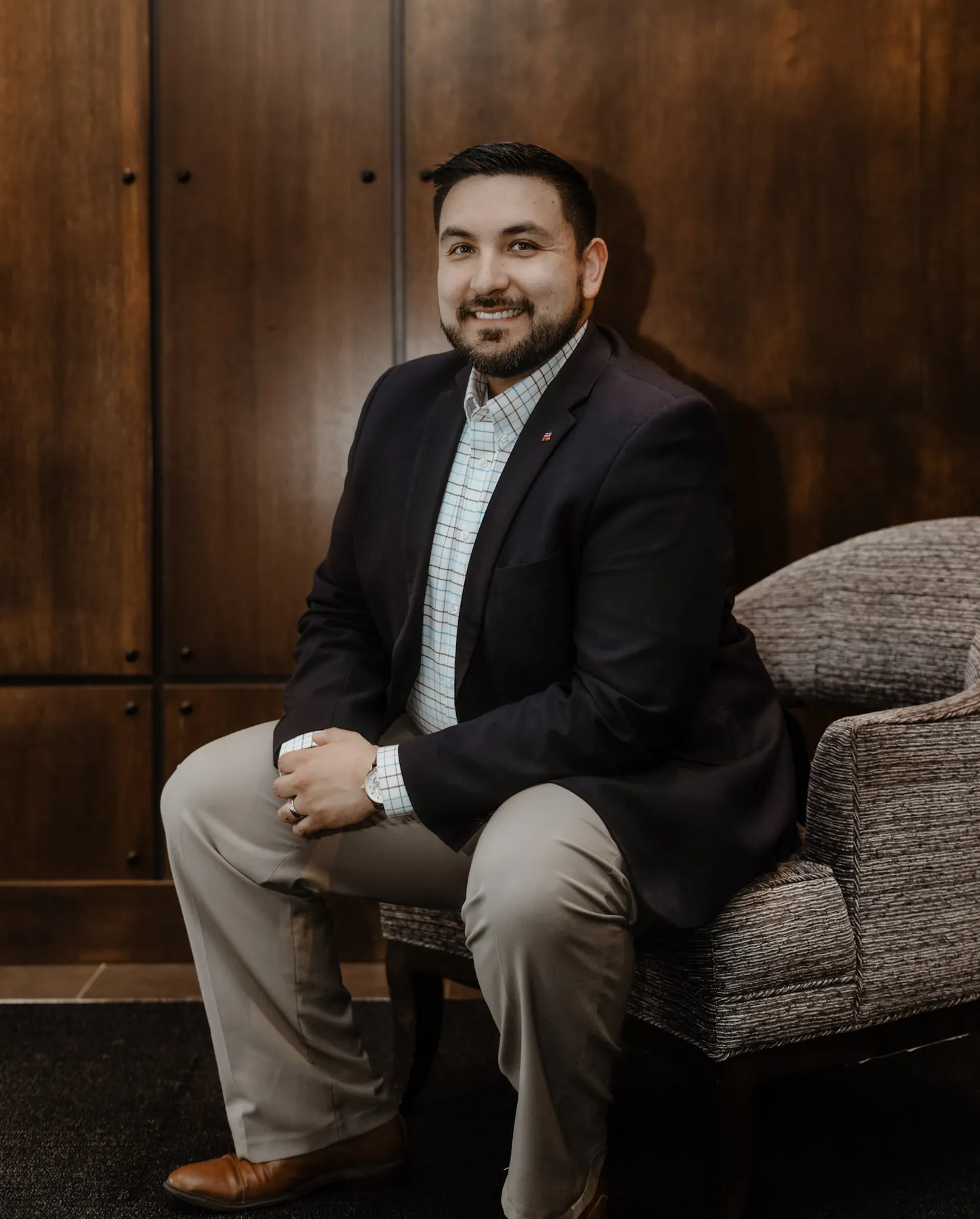 Editorial business portrait of Tyler Tordsen seated in an office armchair