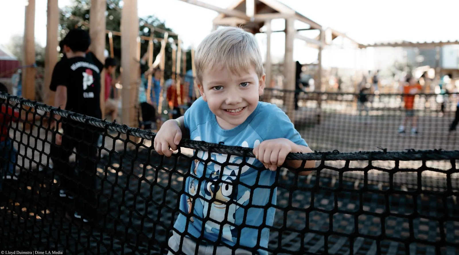 Backlit kids portrait at a playground during golden hour