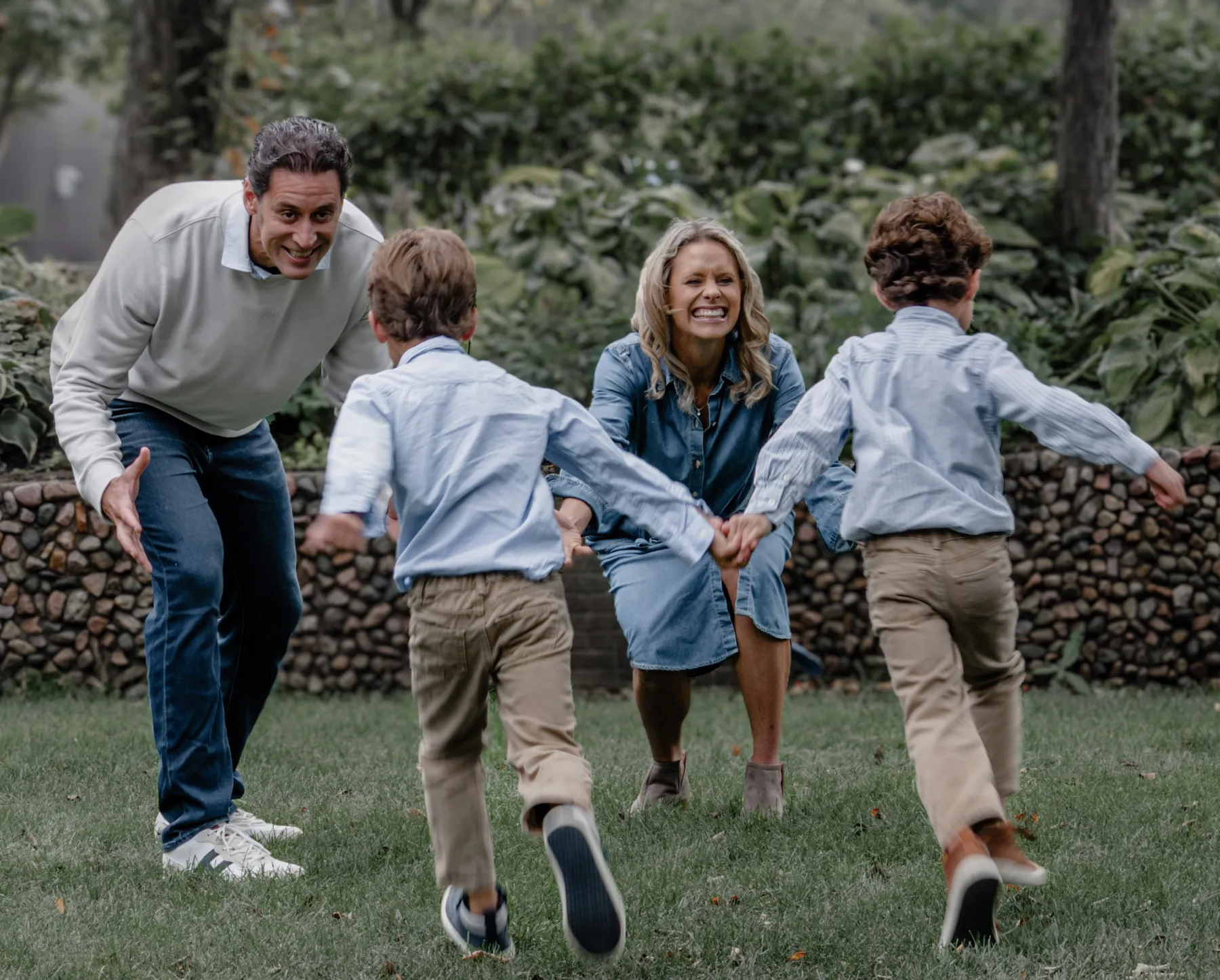 Kids running into their parents' arms, family session